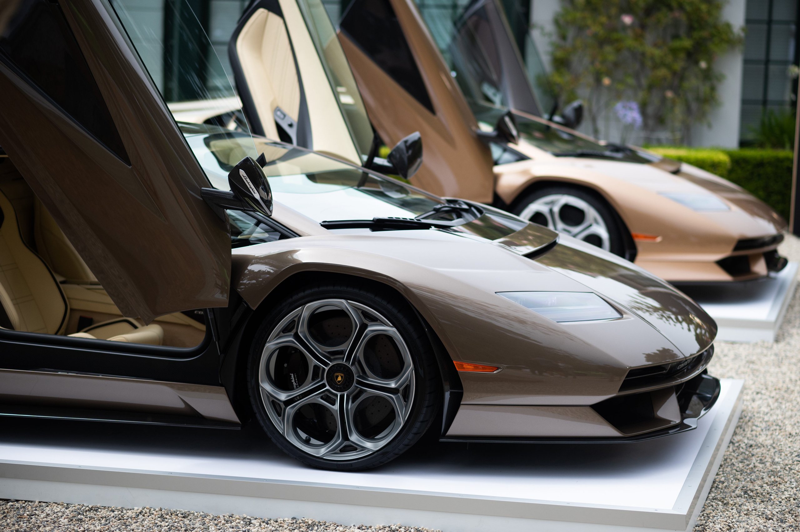 Lamborghini Handed Over Two Countach Lpi 800-4S At Monterey, And The Real Story Is What That Ceremony Signals 7 Side view of two lamborghini countach lpi 800-4 models with scissor doors open showing large brake calipers through multi-spoke wheels