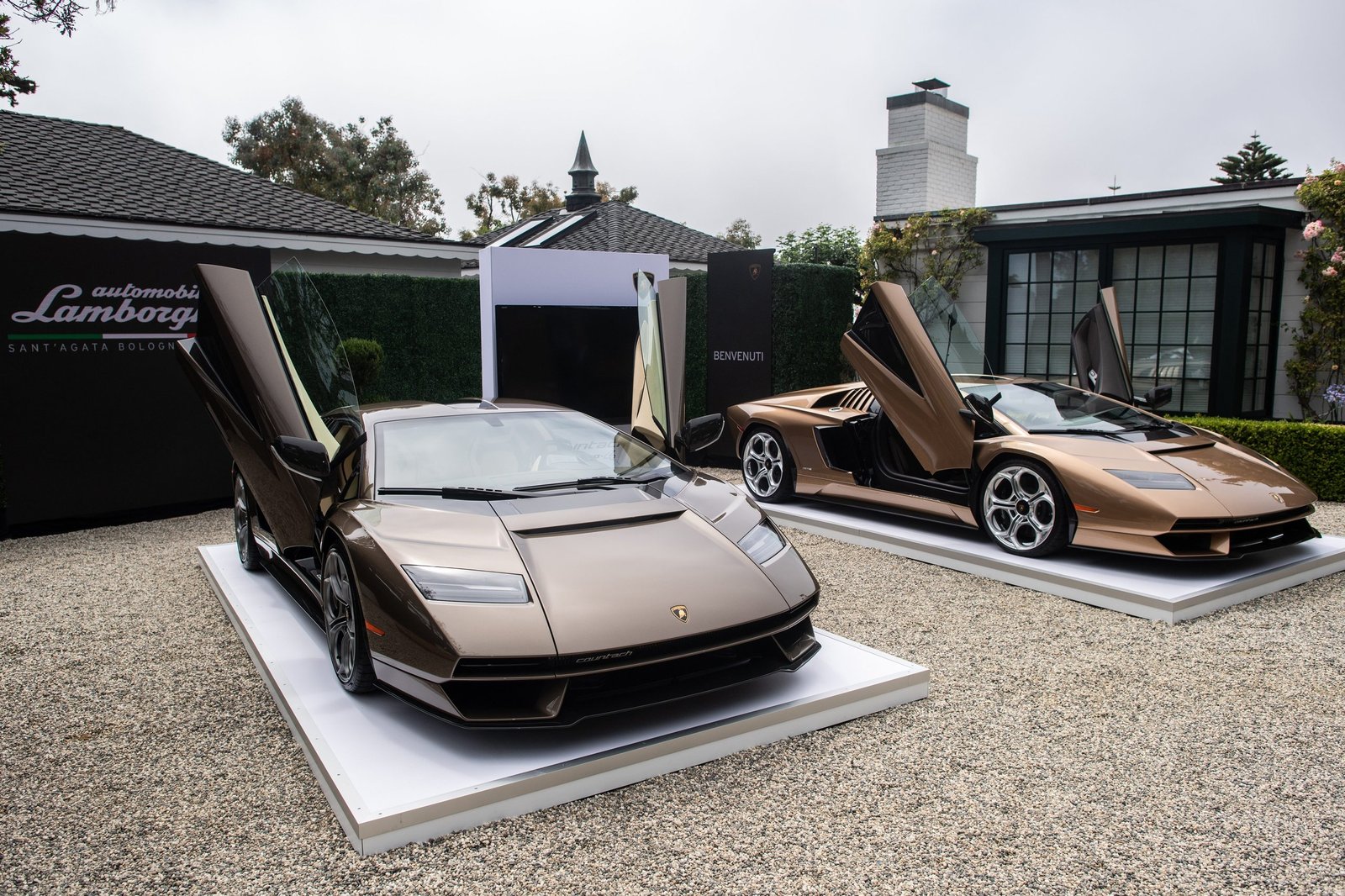 Two bronze Lamborghini Countach LPI 800-4 supercars displayed with scissor doors open at Monterey Car Week 2022