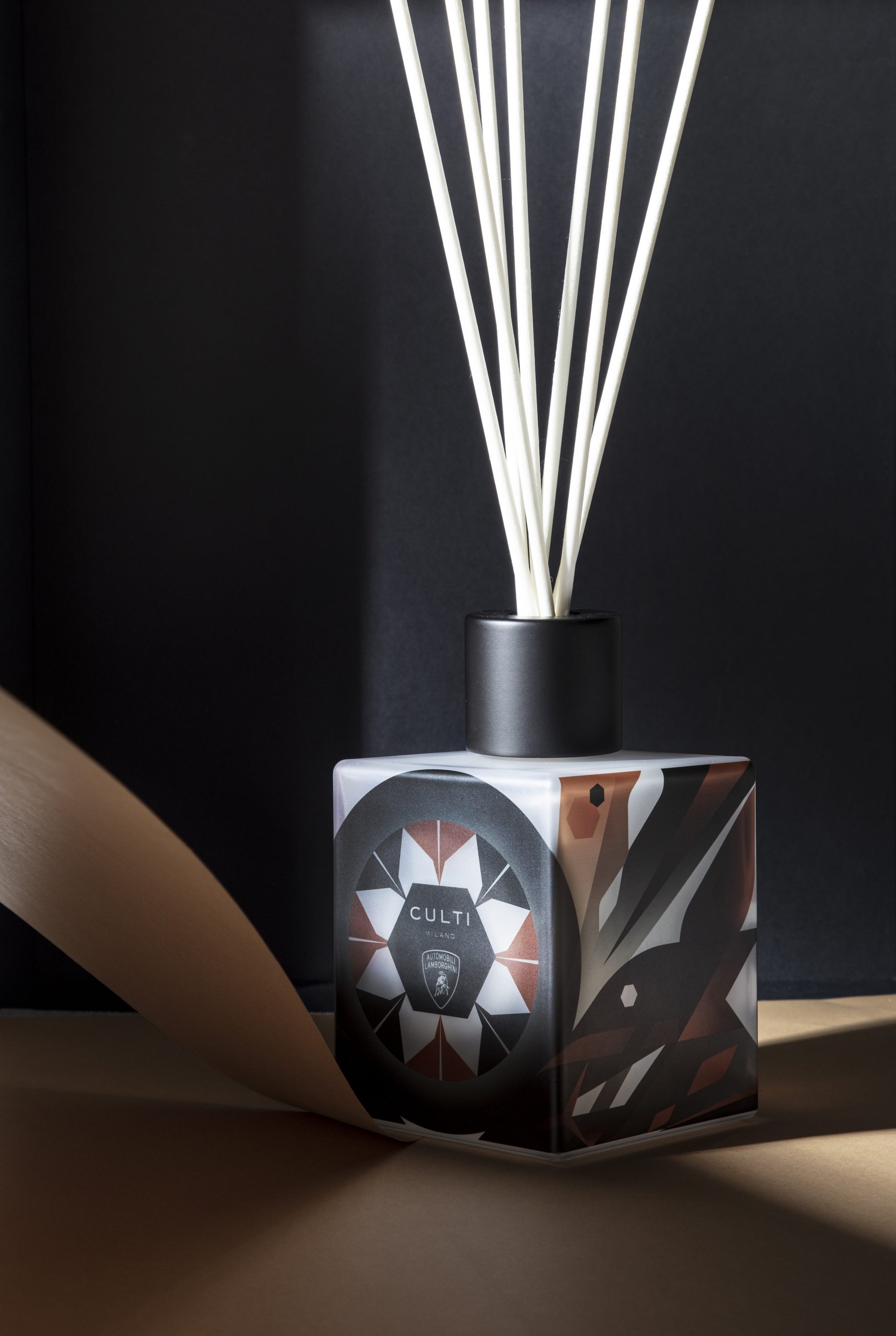 Culti milano for automobili lamborghini reed diffuser with beige ribbon against a dark background