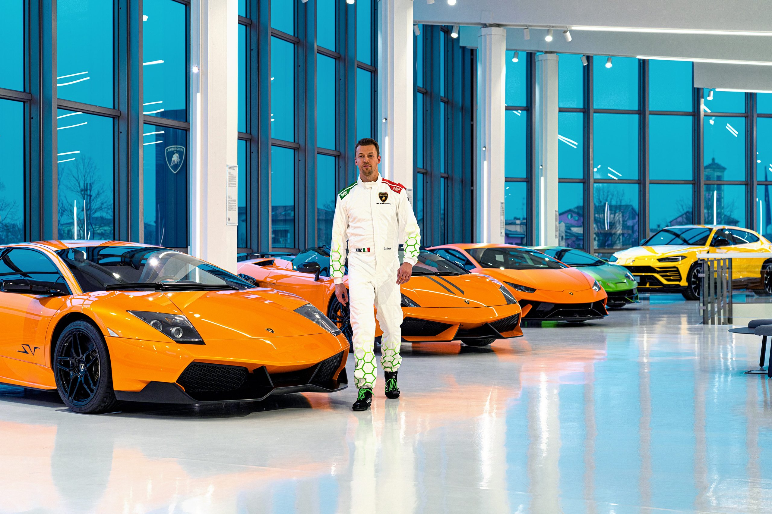 Kvyat'S F1 Pedigree Becomes Lamborghini'S Lmdh Development Weapon 5 Daniil kvyat walking through lamborghini showroom surrounded by murciélago sv, huracán, and urus models