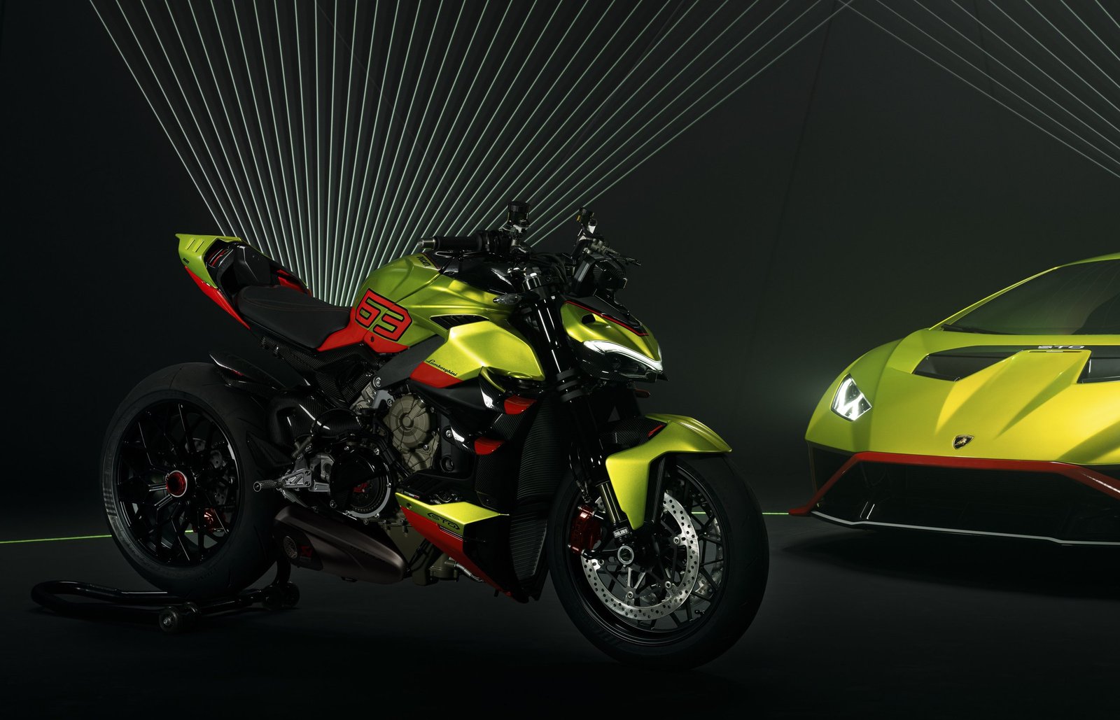 Ducati Streetfighter V4 Lamborghini motorcycle parked beside a matching Lamborghini Huracán STO in Verde Citrea green in a dark studio