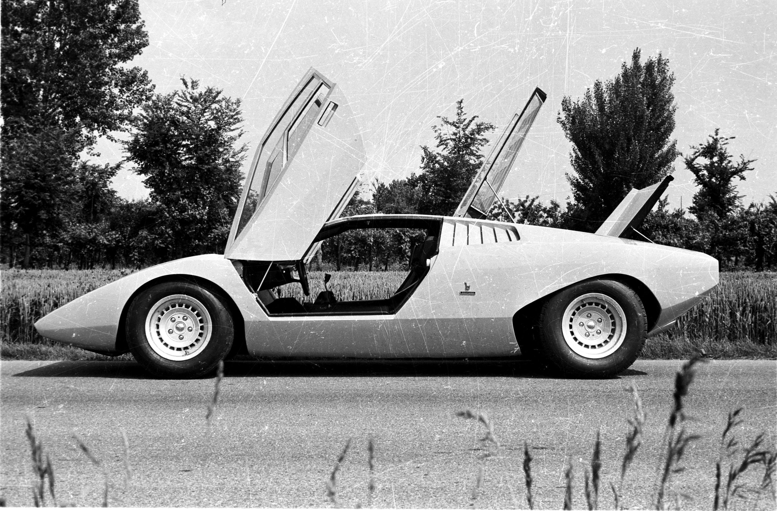 Ferruccio Lamborghini At 105: How A Stubborn Tractor Builder'S Grudge Created An Automotive Dynasty 9 Black and white photograph of the lamborghini countach lp500 concept with its iconic scissor doors open on an asphalt road