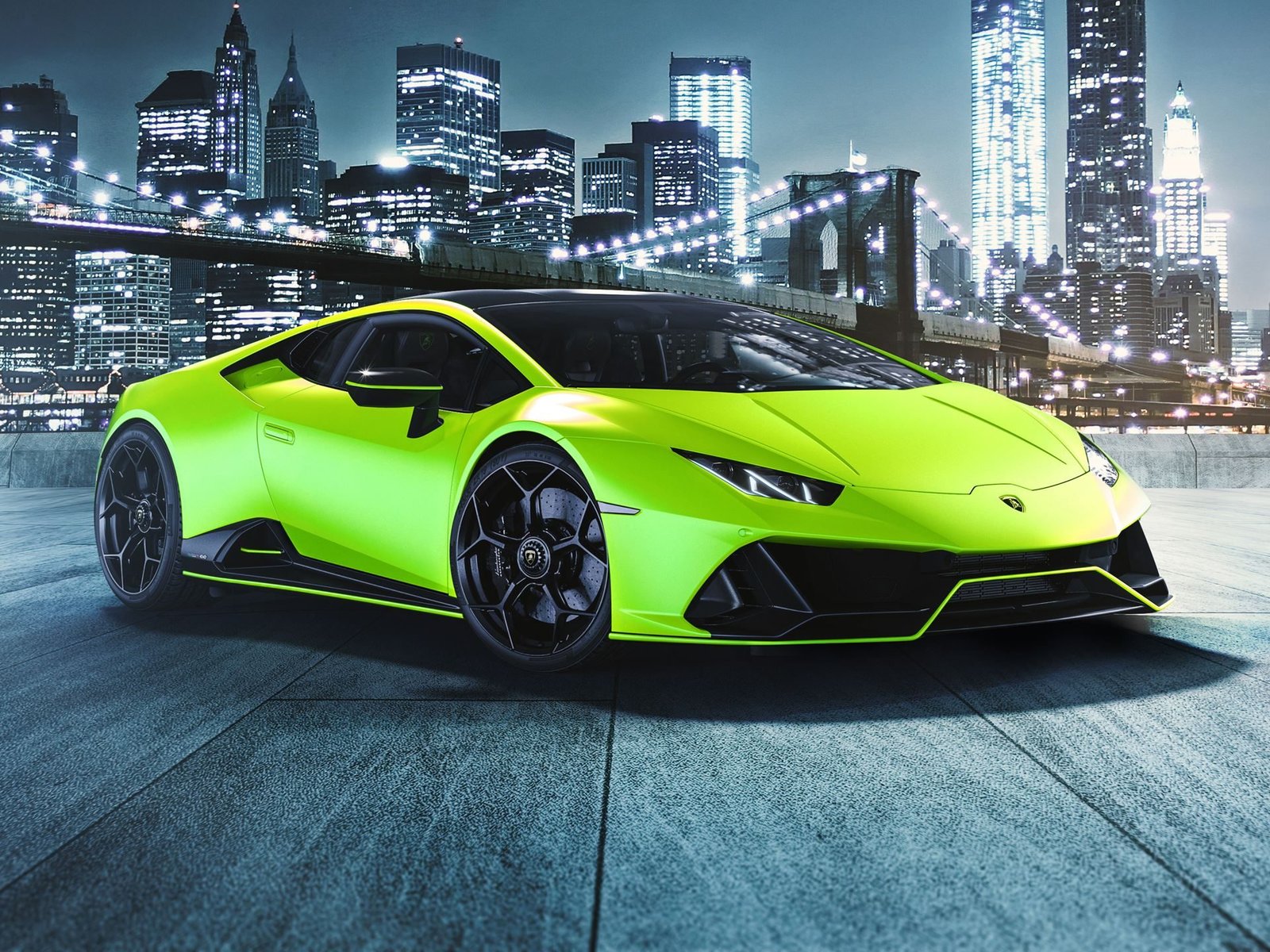 Lamborghini Huracán EVO Fluo Capsule in Verde Shock matte green against a nighttime cityscape