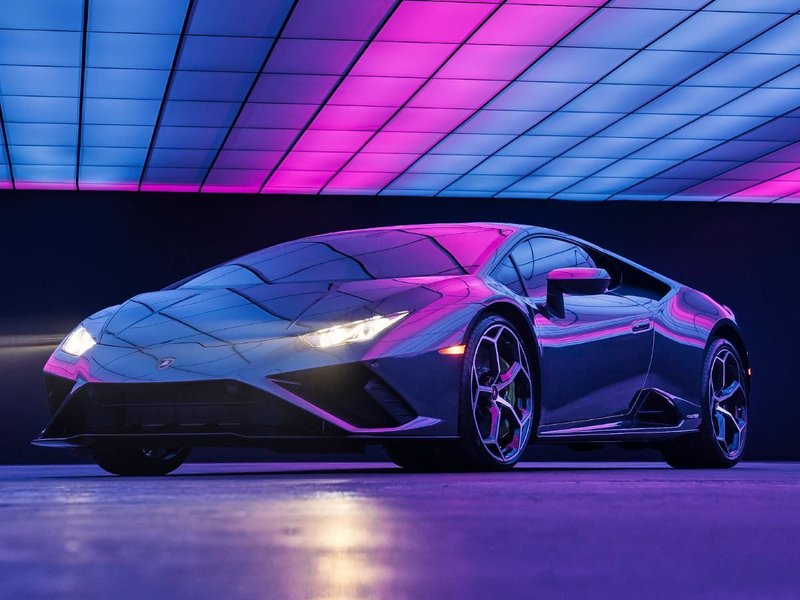 Lamborghini Huracán EVO RWD bathed in pink and blue neon studio lighting, the car featured in Lady Gaga's 911 music video charity sweepstake