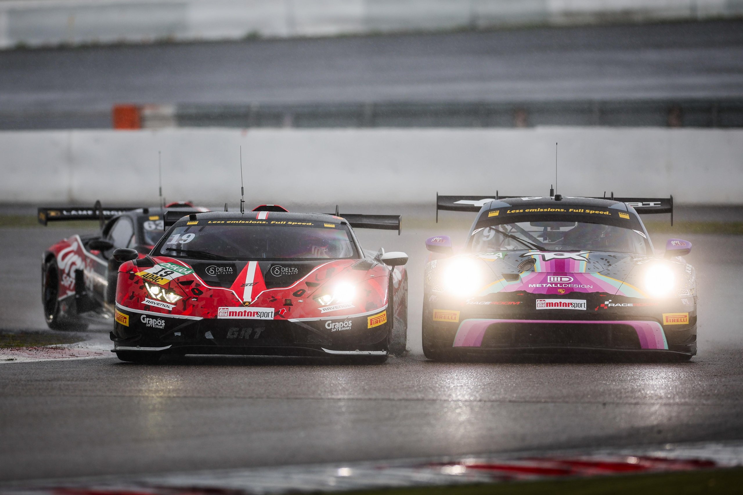 150 Gt3 Wins In Ten Years: How The Huracán Built Lamborghini'S Racing Credibility 7 Lamborghini huracán gt3 evo2 racing side-by-side with a competitor on a wet track with headlights on