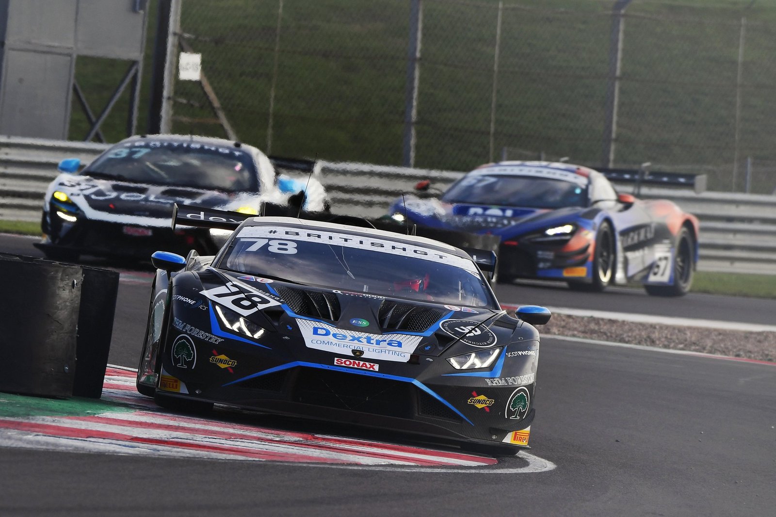 Barwell Motorsport's #78 Lamborghini Huracán GT3 EVO2 leads two rival cars through a corner at Donington Park during the British GT Championship finale
