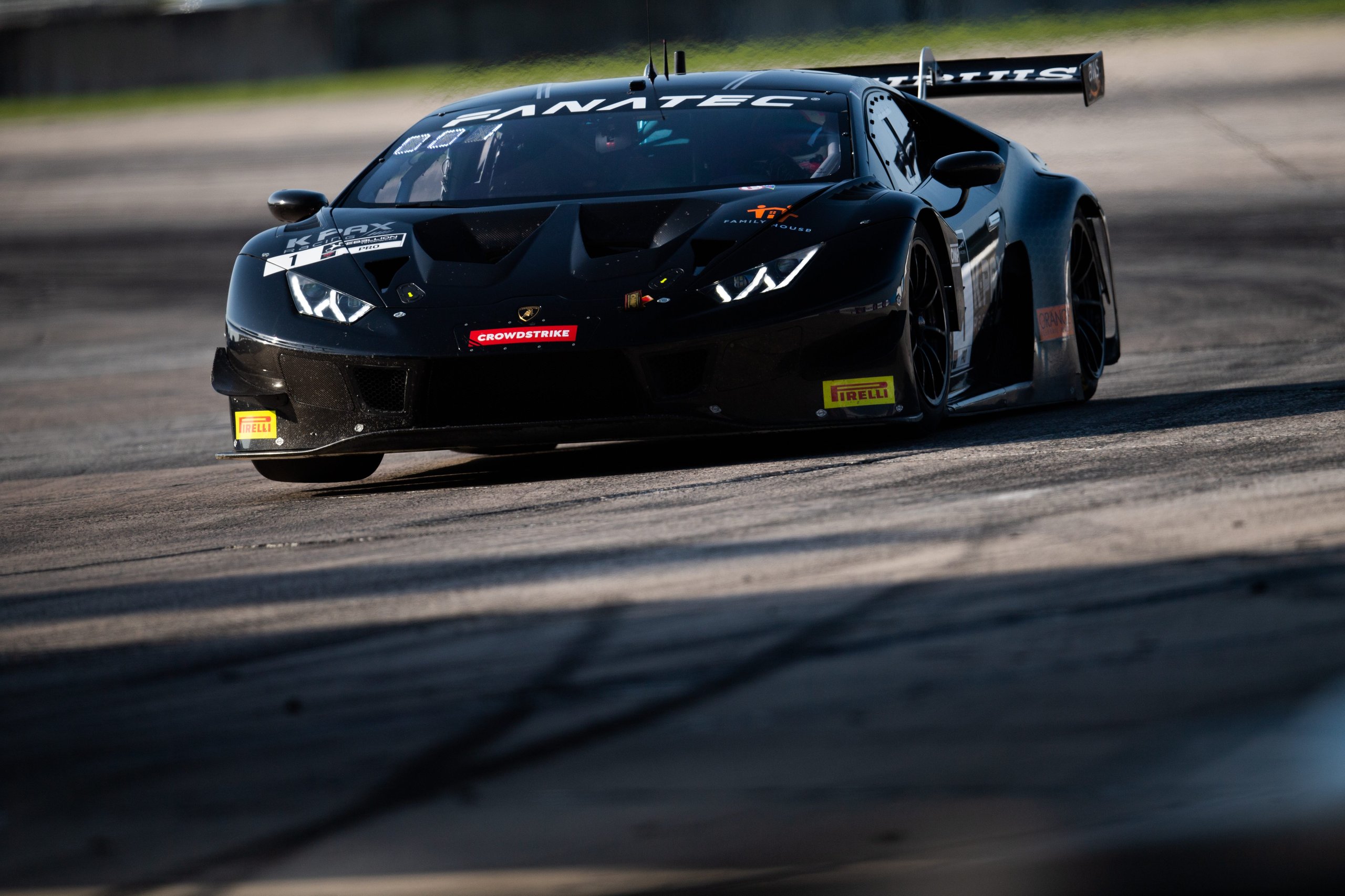 K-Pax Racing'S Sebring Sweep Clinches Back-To-Back Gt World Challenge America Titles For Lamborghini 5 Front view of k-pax racing lamborghini huracán gt3 evo approaching on track with headlights illuminated
