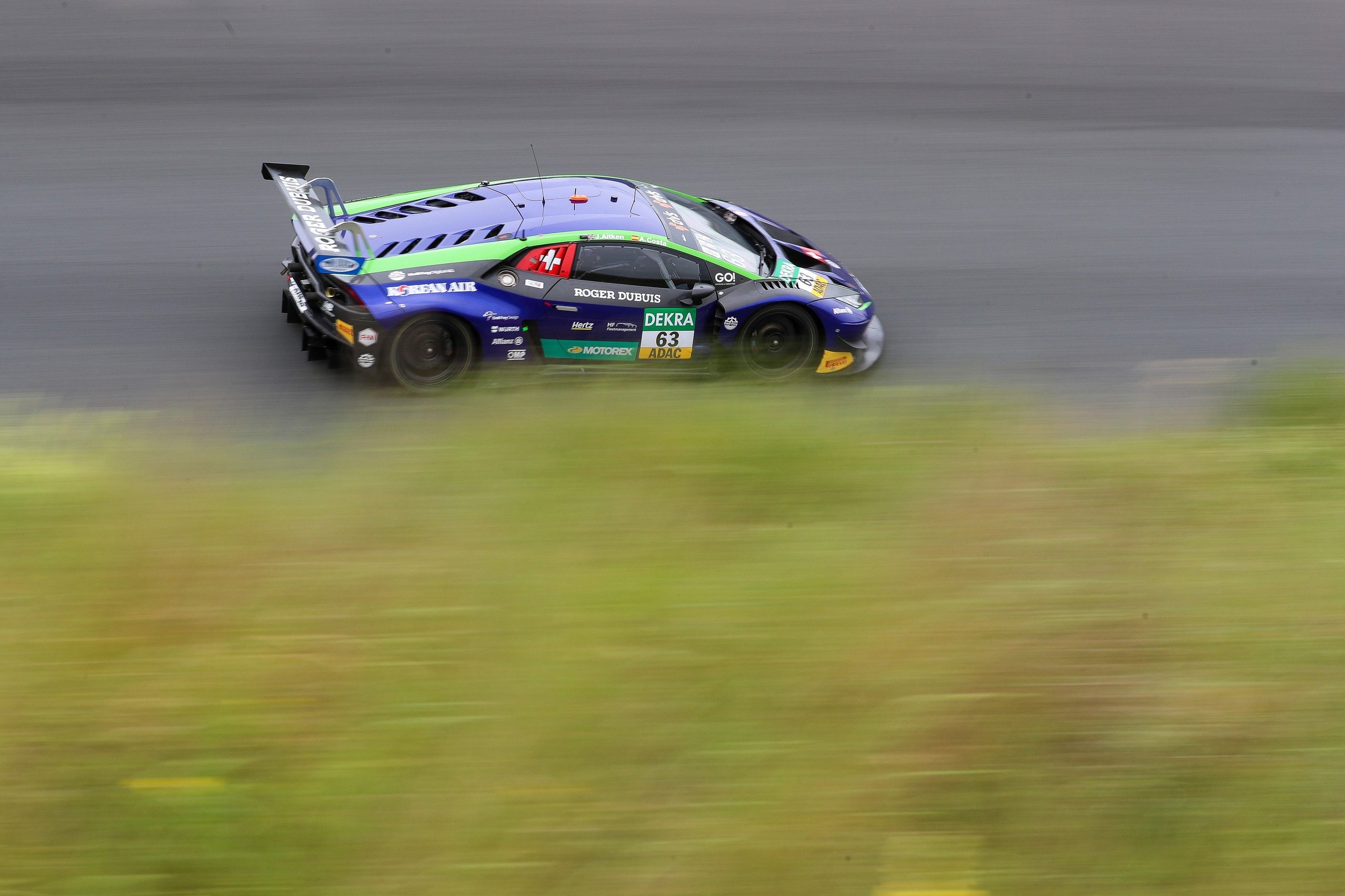Emil Frey Racing'S Zandvoort Sweep Proves The Huracán Gt3 Evo Still Owns The Adac Gt Masters Grid 3 Emil frey racing lamborghini huracán gt3 evo in blue, green, and purple livery at speed on the zandvoort circuit
