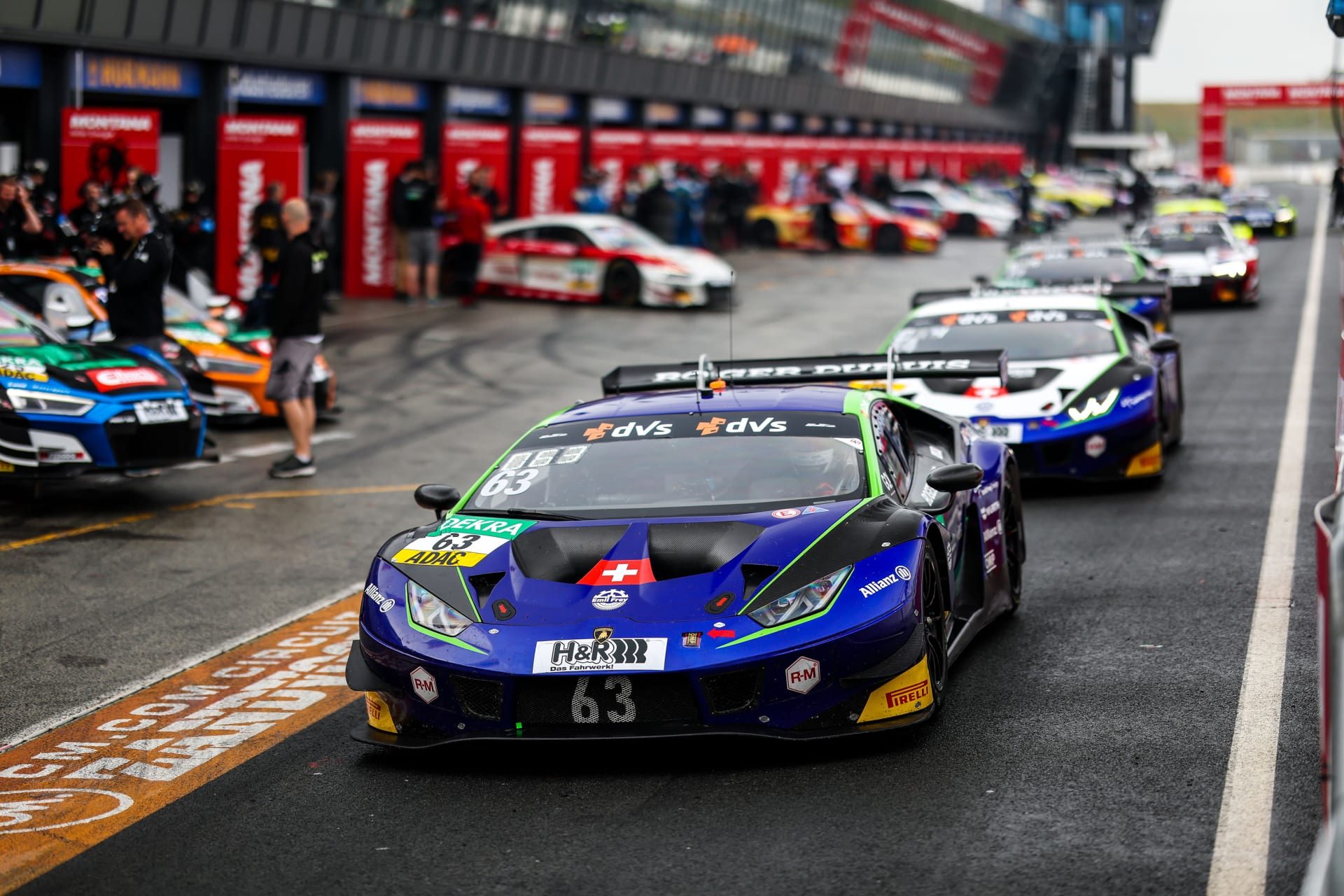 Emil Frey Racing'S Zandvoort Sweep Proves The Huracán Gt3 Evo Still Owns The Adac Gt Masters Grid 7 Line of gt3 race cars led by the emil frey racing lamborghini huracán gt3 evo in the zandvoort pit lane