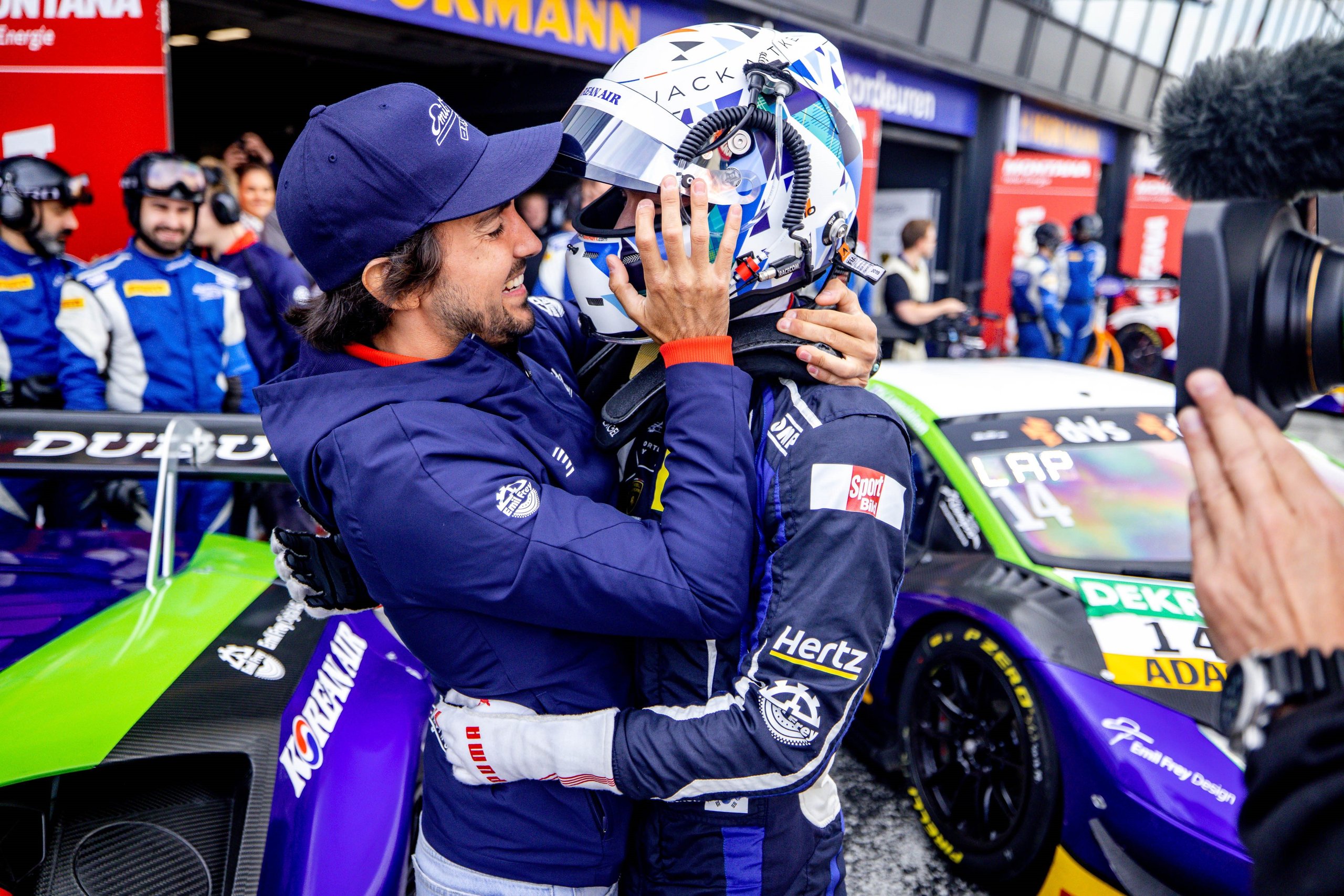Emil Frey Racing'S Zandvoort Sweep Proves The Huracán Gt3 Evo Still Owns The Adac Gt Masters Grid 5 Emil frey racing driver and team member embrace in the pit lane after a victory at zandvoort with the huracán gt3 evo visible in the background