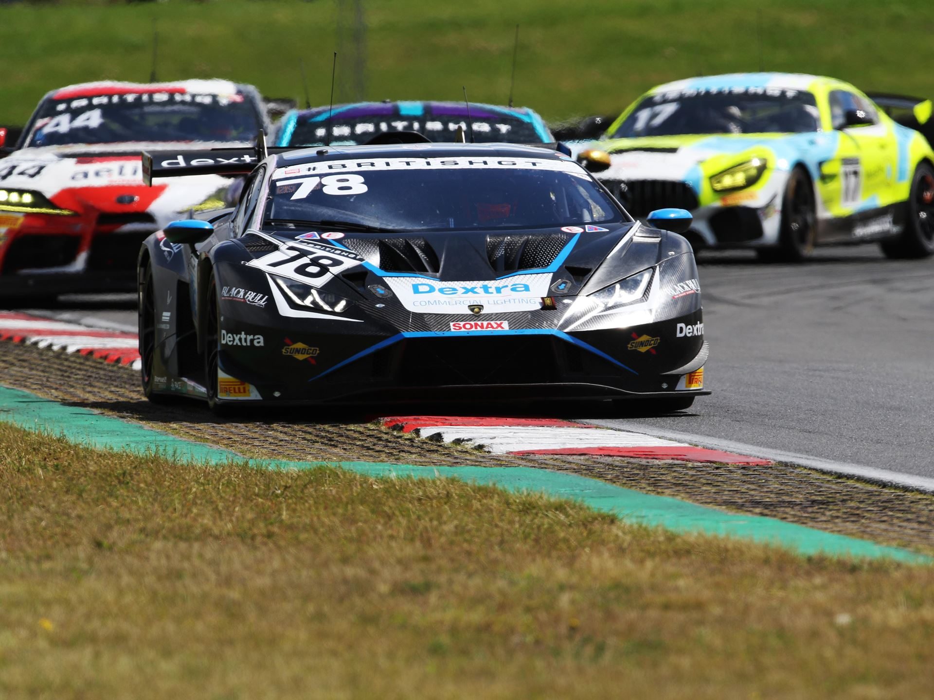 Close-up of the number 78 lamborghini huracán gt3 evo2 on track at snetterton with competitor cars visible behind