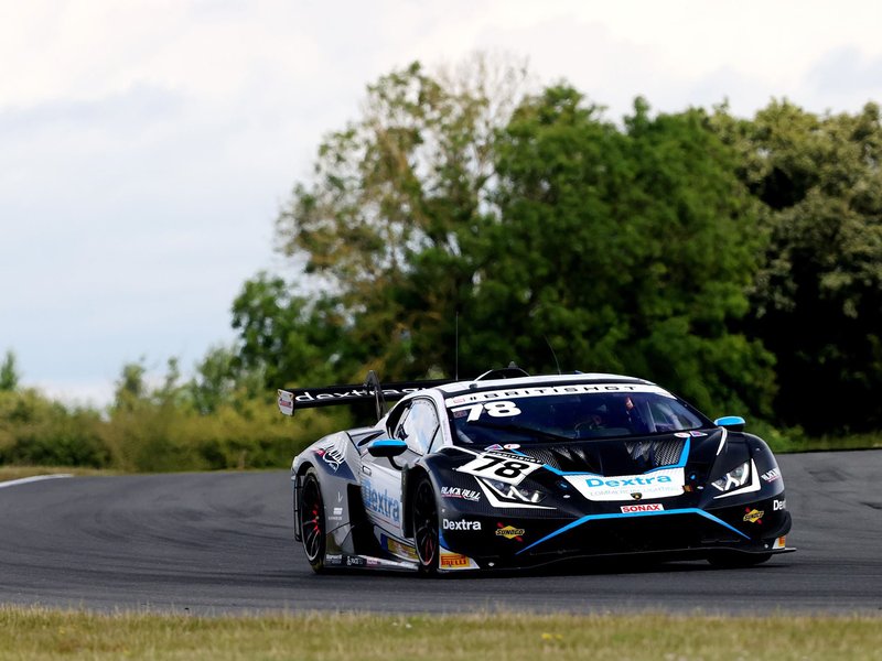 Barwell Motorsport's black number 78 Lamborghini Huracán GT3 EVO2 mid-corner at Snetterton circuit under a cloudy sky