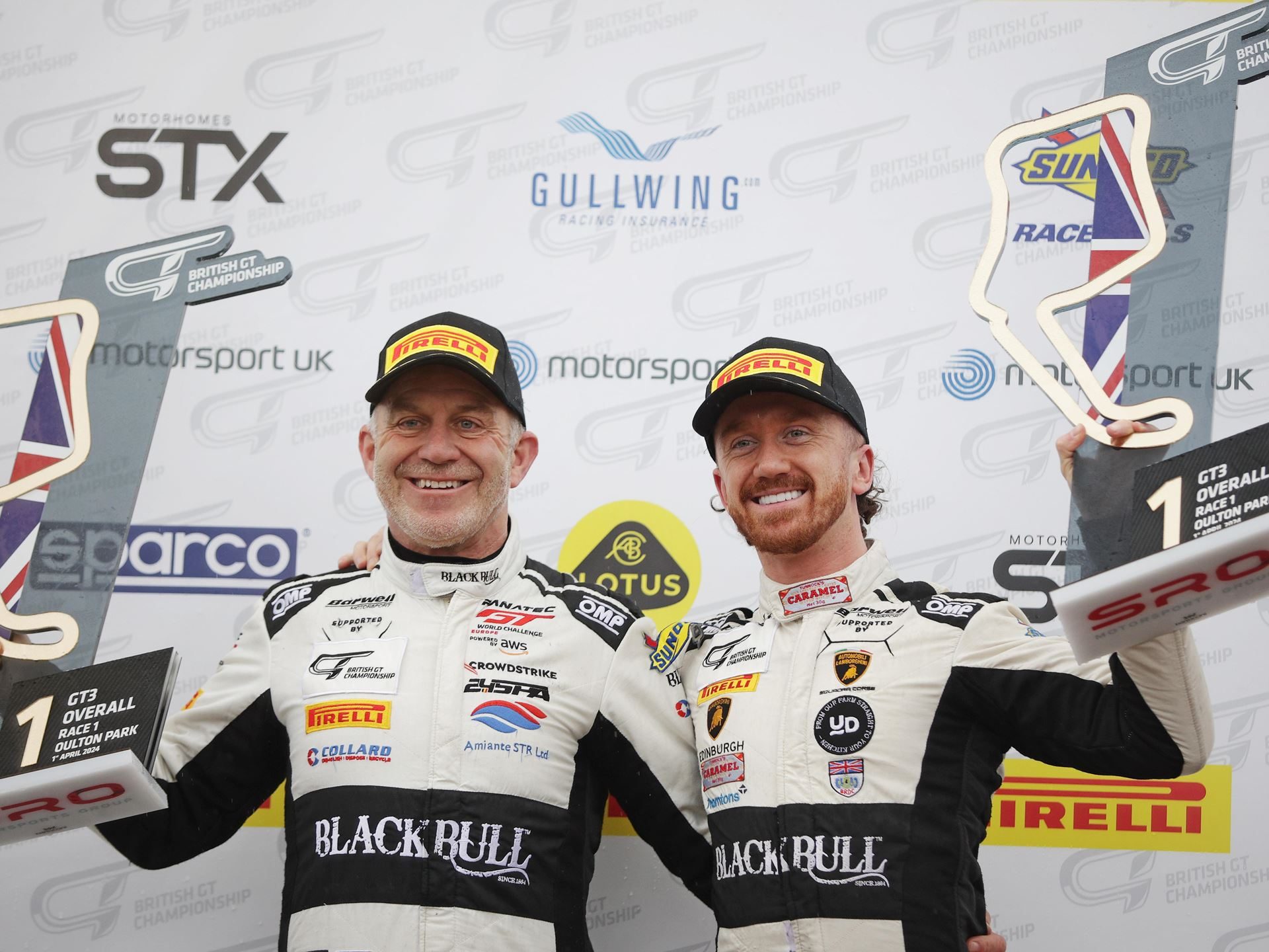 Two Huracán Gt3 Evo2S, Two Wins, One Soaking Wet Oulton Park: Why Lamborghini'S British Gt Opener Matters Beyond The Trophies 5 Rob and ricky collard on the podium holding trophies after winning race 1 at oulton park in the british gt championship