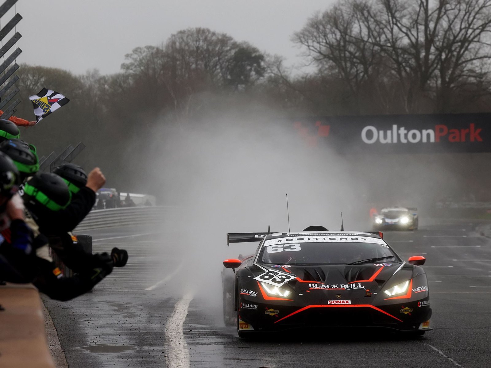 Lamborghini Huracán GT3 EVO2 number 63 racing through heavy spray at Oulton Park during the 2024 British GT Championship opener