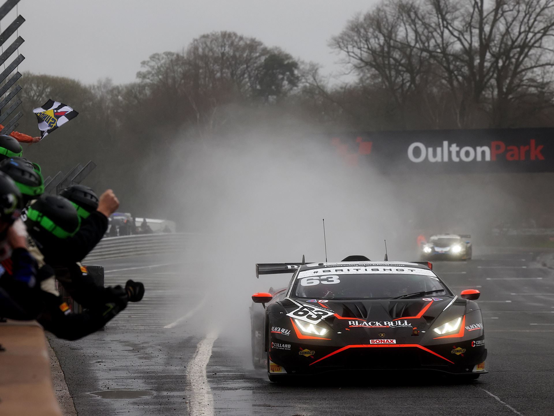 Lamborghini huracán gt3 evo2 number 63 racing through heavy spray at oulton park during the 2024 british gt championship opener