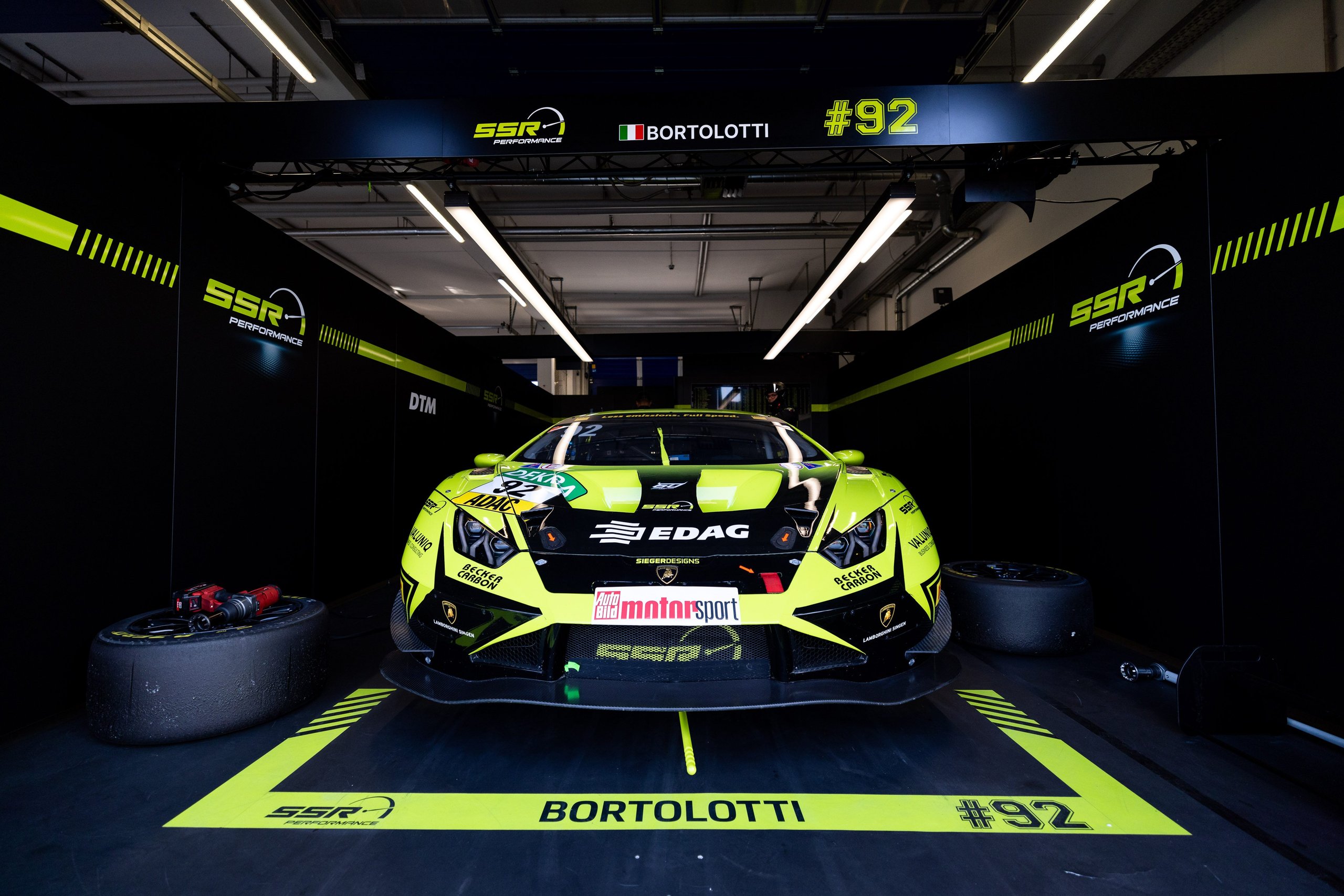 Lamborghini huracán gt3 evo2 number 92 in ssr performance pit garage with bortolotti name visible on floor