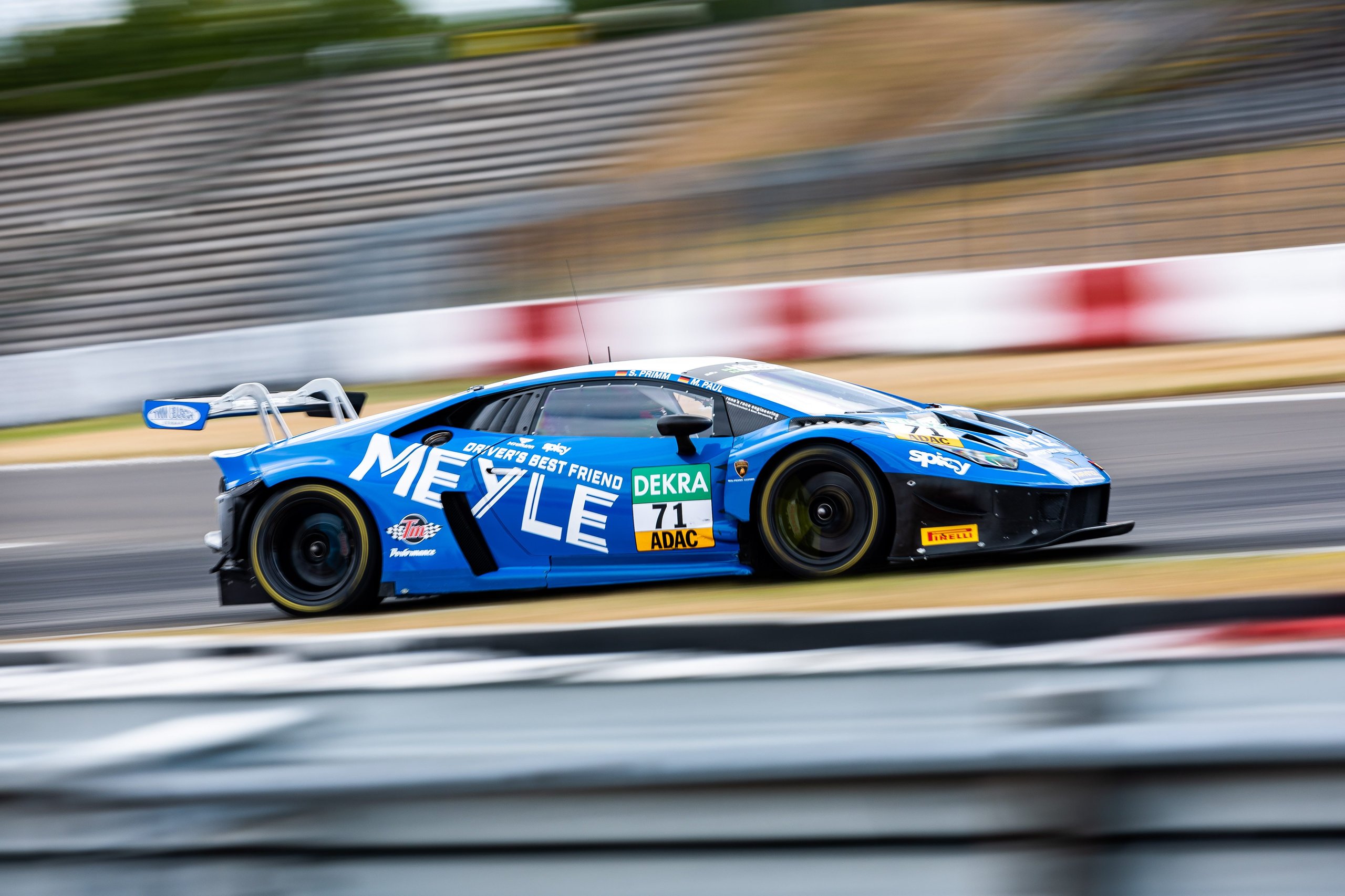 Huracán Gt3 Evo2 Scores Double Weekend Wins As Lamborghini Hits 50Th Adac Gt Masters Pole 7 Blue lamborghini huracán gt3 evo2 number 71 cornering at speed with motion blur