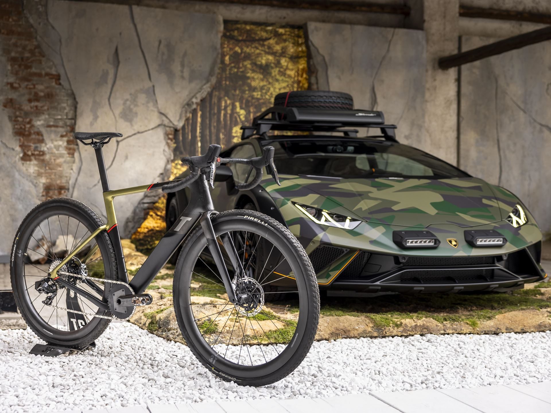 Twelve Camouflaged Sterrattos, A Michelin-Starred Dinner, And Tod'S Loafers: Inside Lamborghini'S Milan Design Week Power Play 13 Huracán sterrato in camouflage livery parked behind a 3t gravel bicycle, illustrating the adventure lifestyle theme