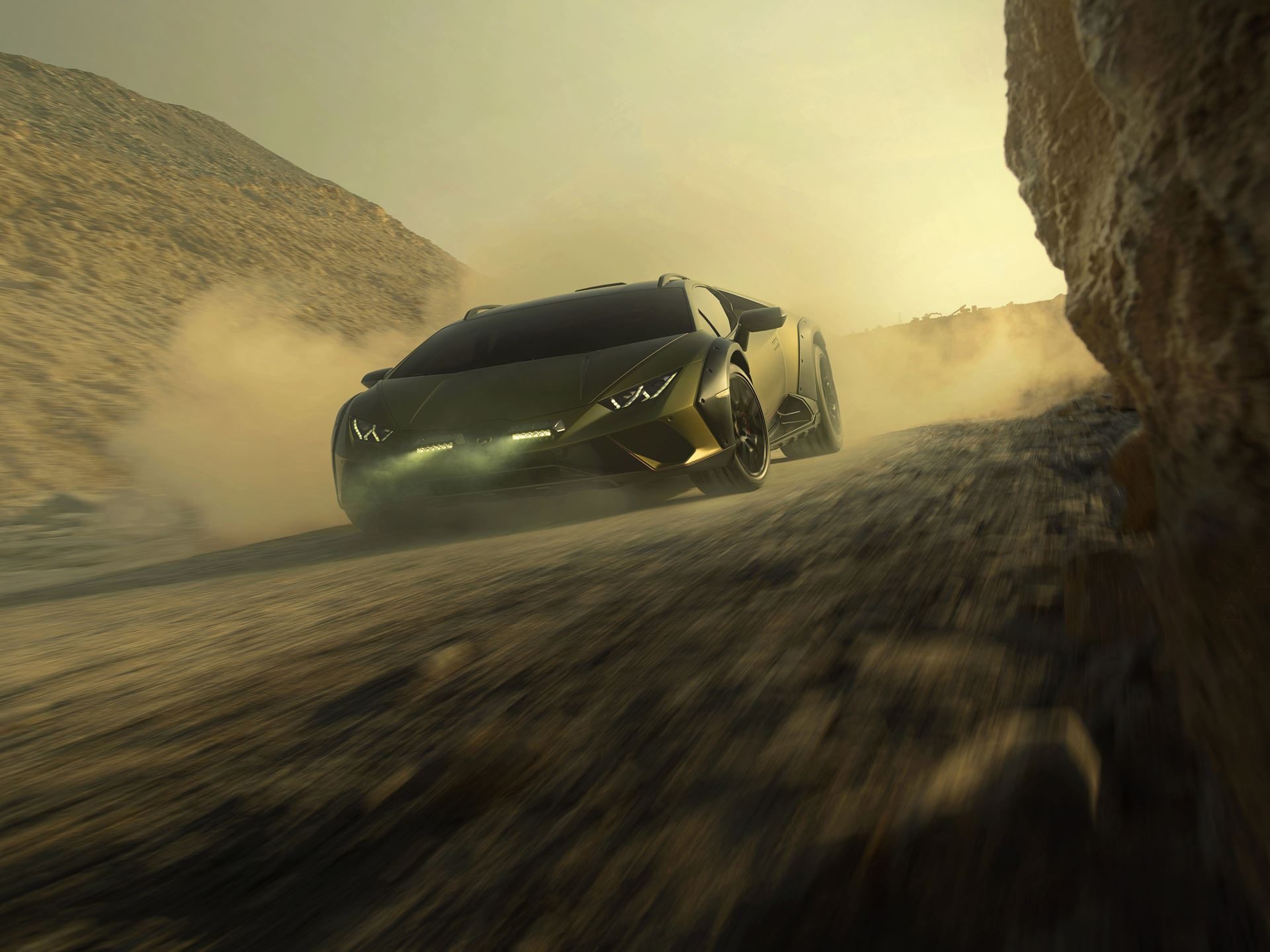 The Huracán Sterrato Sent Lamborghini'S V10 Off The Road And Into Collector History 5 Lamborghini huracán sterrato in verde gea speeding through dusty rocky desert with rally lights illuminated