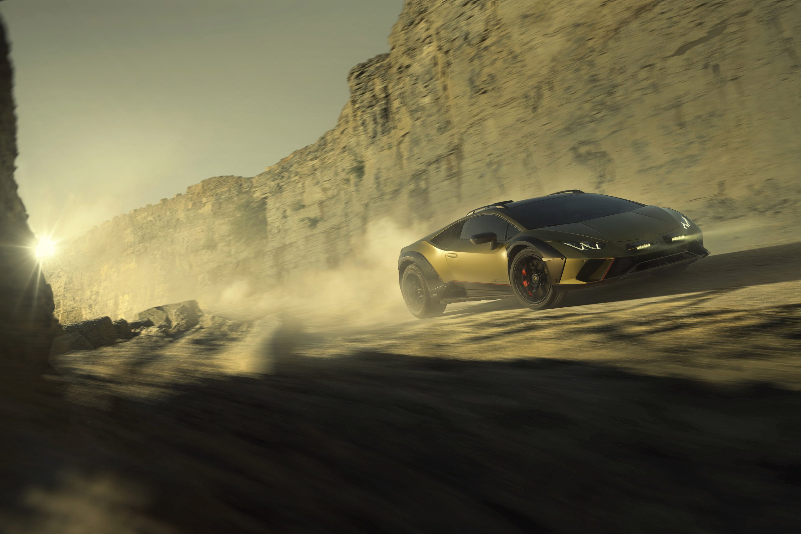The Huracán Sterrato Sent Lamborghini'S V10 Off The Road And Into Collector History 9 Lamborghini huracán sterrato in verde gea speeding through dusty desert at sunset with rally lights on