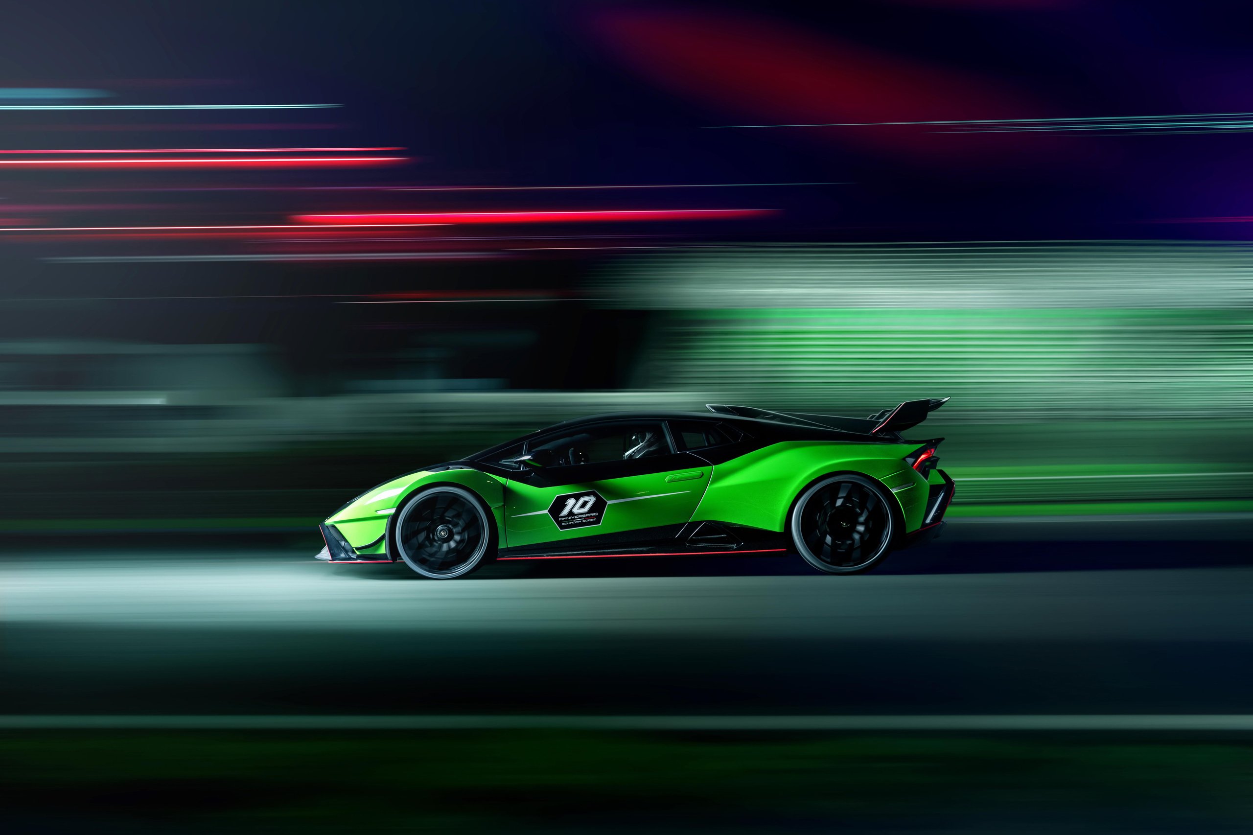 Squadra Corse'S First Road-Car Performance Kit Turns The Huracán Sto Into A Factory-Built Track Weapon 5 Side profile of huracán sto sc 10° anniversario at speed on track at night showing racing livery and 10 decal