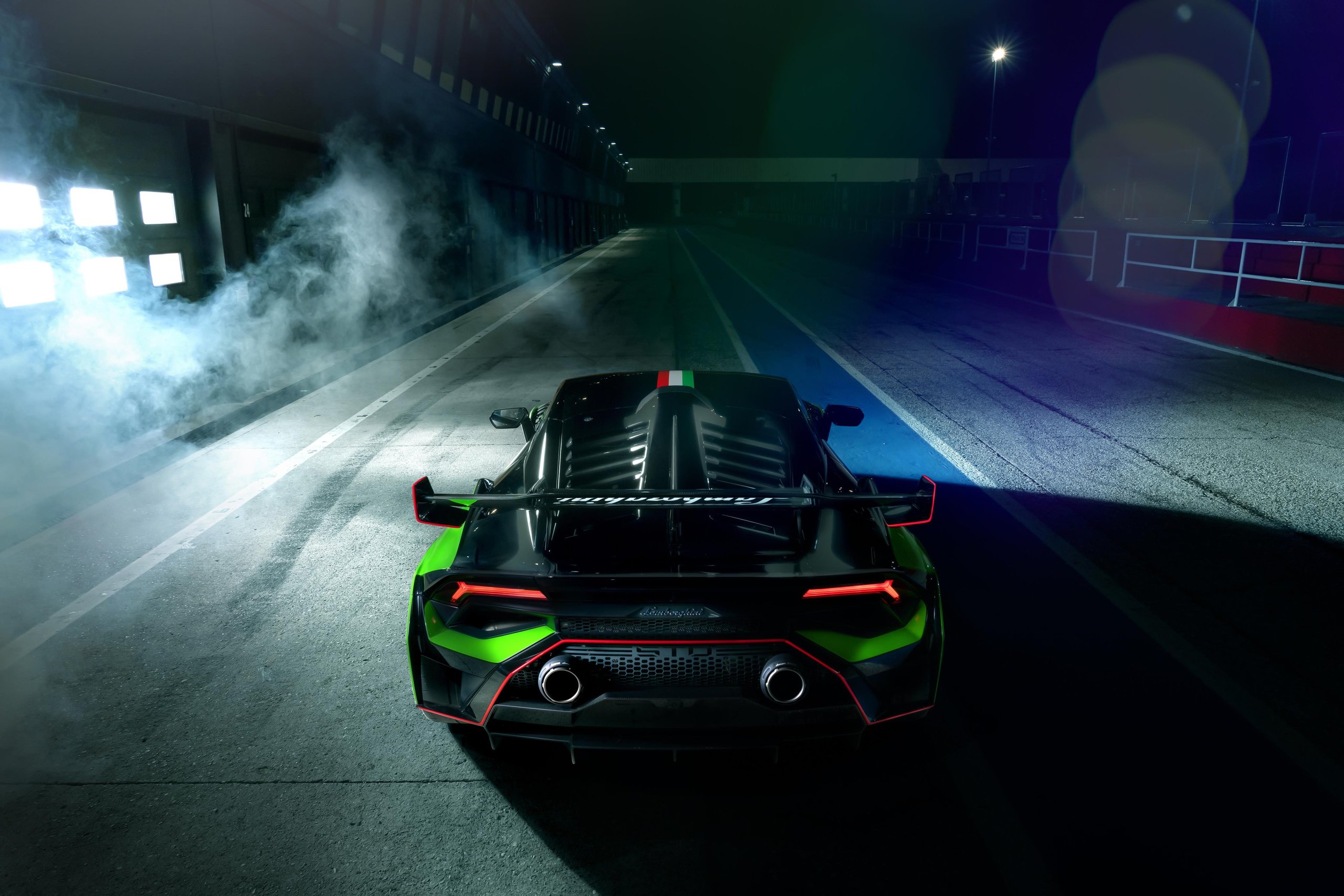 Squadra Corse'S First Road-Car Performance Kit Turns The Huracán Sto Into A Factory-Built Track Weapon 7 Rear view of huracán sto sc 10° anniversario in pit lane showing rear wing, diffuser, dual exhaust, and italian flag stripe