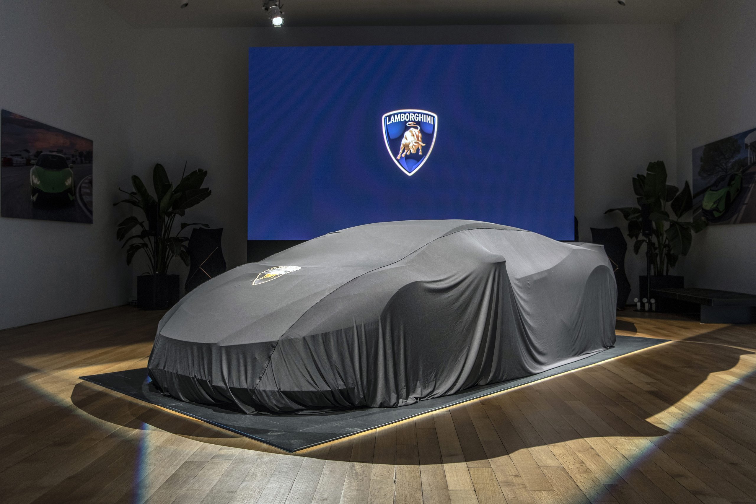 Huracán Tecnica In New York: Why Lamborghini'S V10 Sweet Spot Matters More Than Its Spec Sheet 7 Lamborghini huracán tecnica under a dark grey car cover on the reveal platform at the lamborghini lounge nyc, moments before its north american unveiling