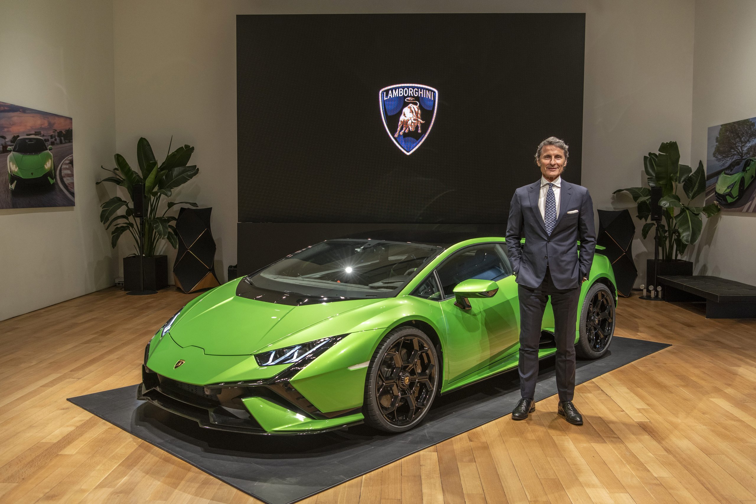Huracán Tecnica In New York: Why Lamborghini'S V10 Sweet Spot Matters More Than Its Spec Sheet 5 Lamborghini executive standing beside the green huracán tecnica showing the car's aggressive front fascia and aerodynamic profile