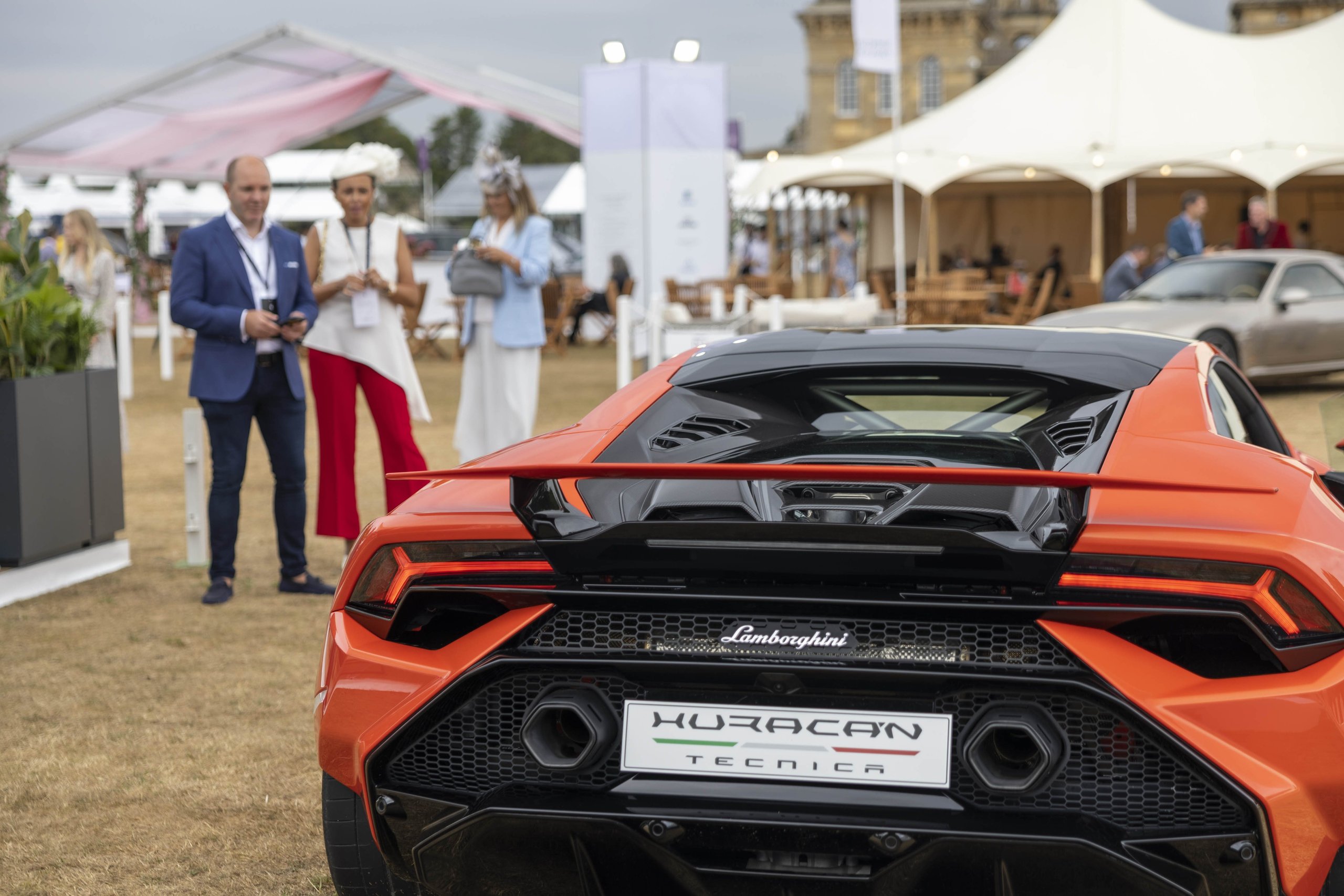 Lamborghini Paired The Huracán Tecnica With Its Rarest Classics At Salon Privé, And The Subtext Was Deliberate 3 Rear view of the orange lamborghini huracán tecnica showing hexagonal exhaust tips, rear diffuser, and tecnica badging at salon privé