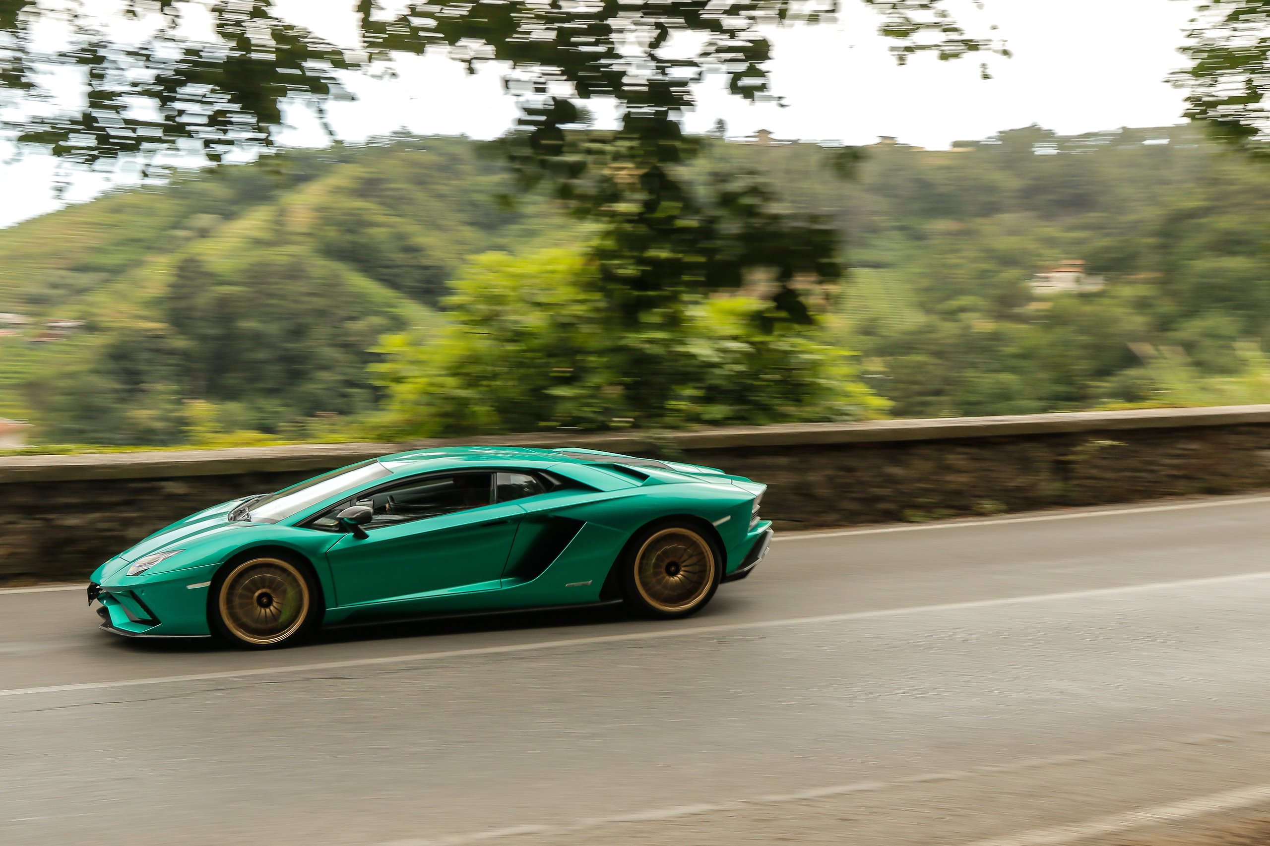 Lamborghini'S €1.8 Billion Gamble: Record 2021 Profits Fund The End Of Pure Combustion 7 Green lamborghini aventador svj driving on a winding mountain road