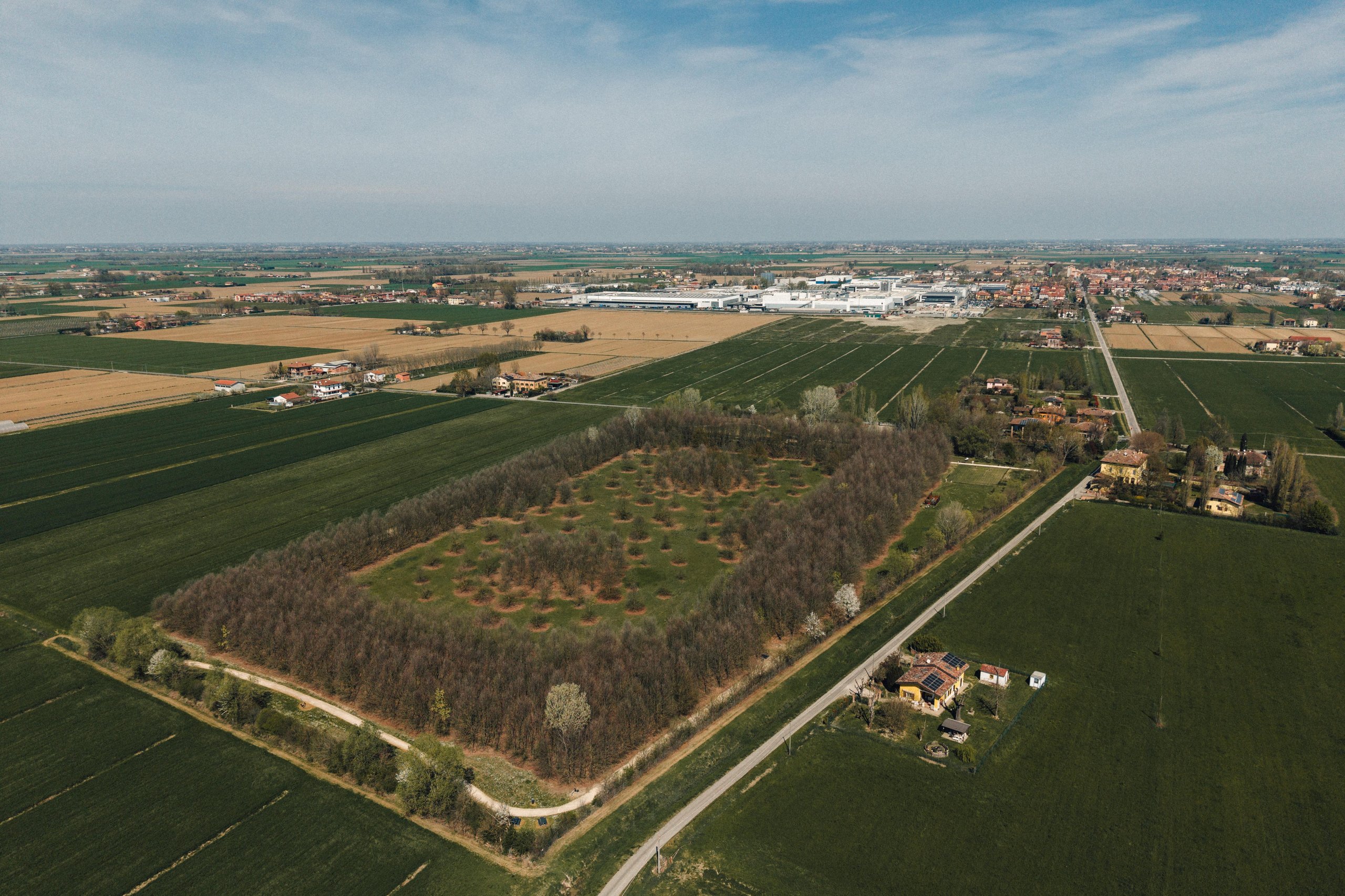 Aerial view of the lamborghini factory complex in sant'agata bolognese surrounded by green agricultural fields