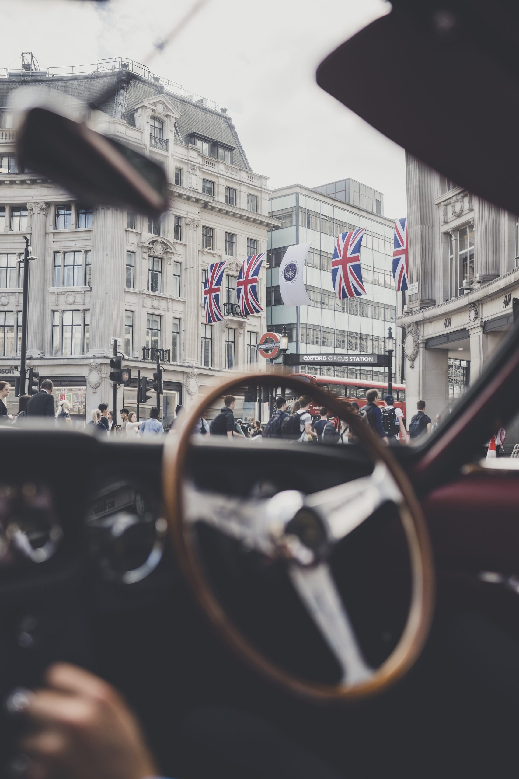 Lamborghini Celebrates The Beatles' Legacy With A 400 Gt 2+2 London Tour 5 Interior view of the lamborghini 400 gt 2+2 looking through the windshield at oxford circus with union jack flags visible