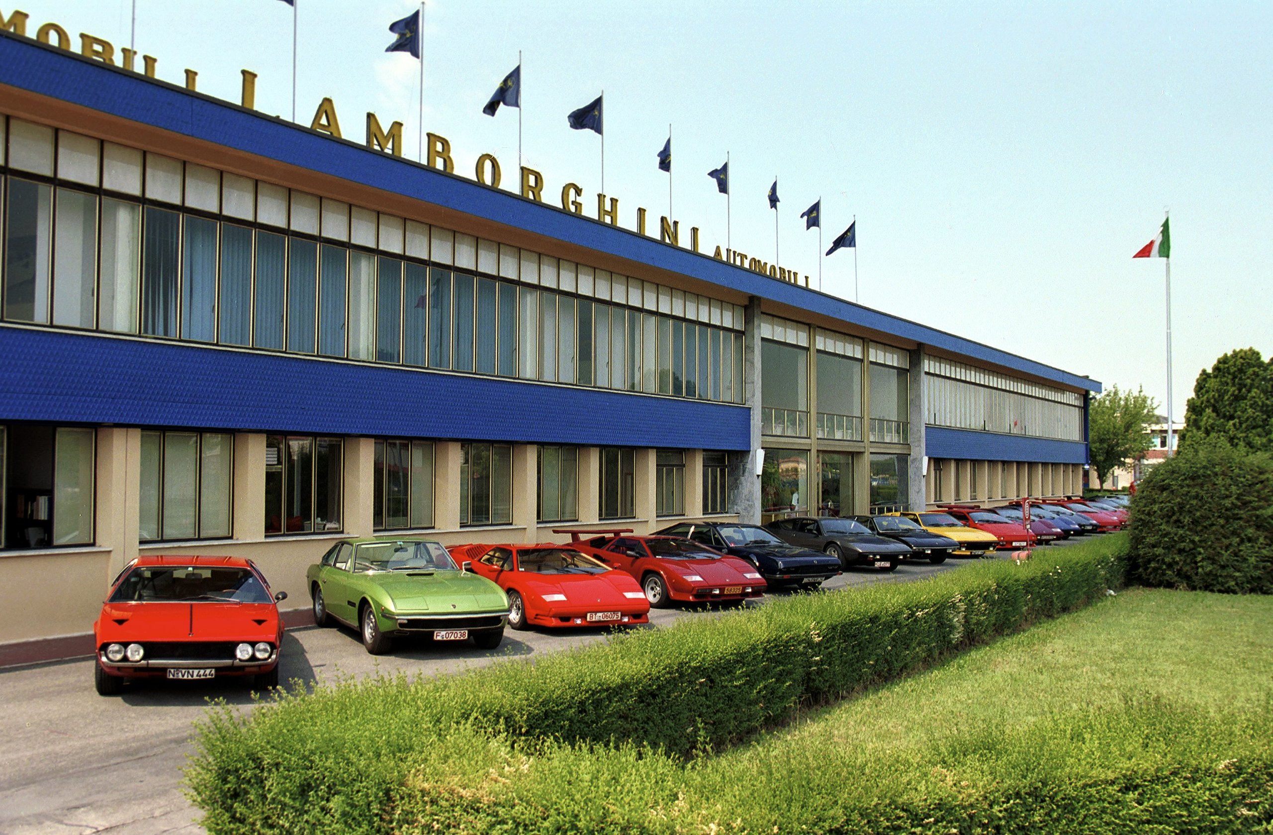 Lamborghini At 60: Global Owner Gatherings And Two 60-Unit Huracans Mark Six Decades Of Defiance 3 Classic lamborghini models including a miura and countach lined up in front of the historic automobili lamborghini factory building