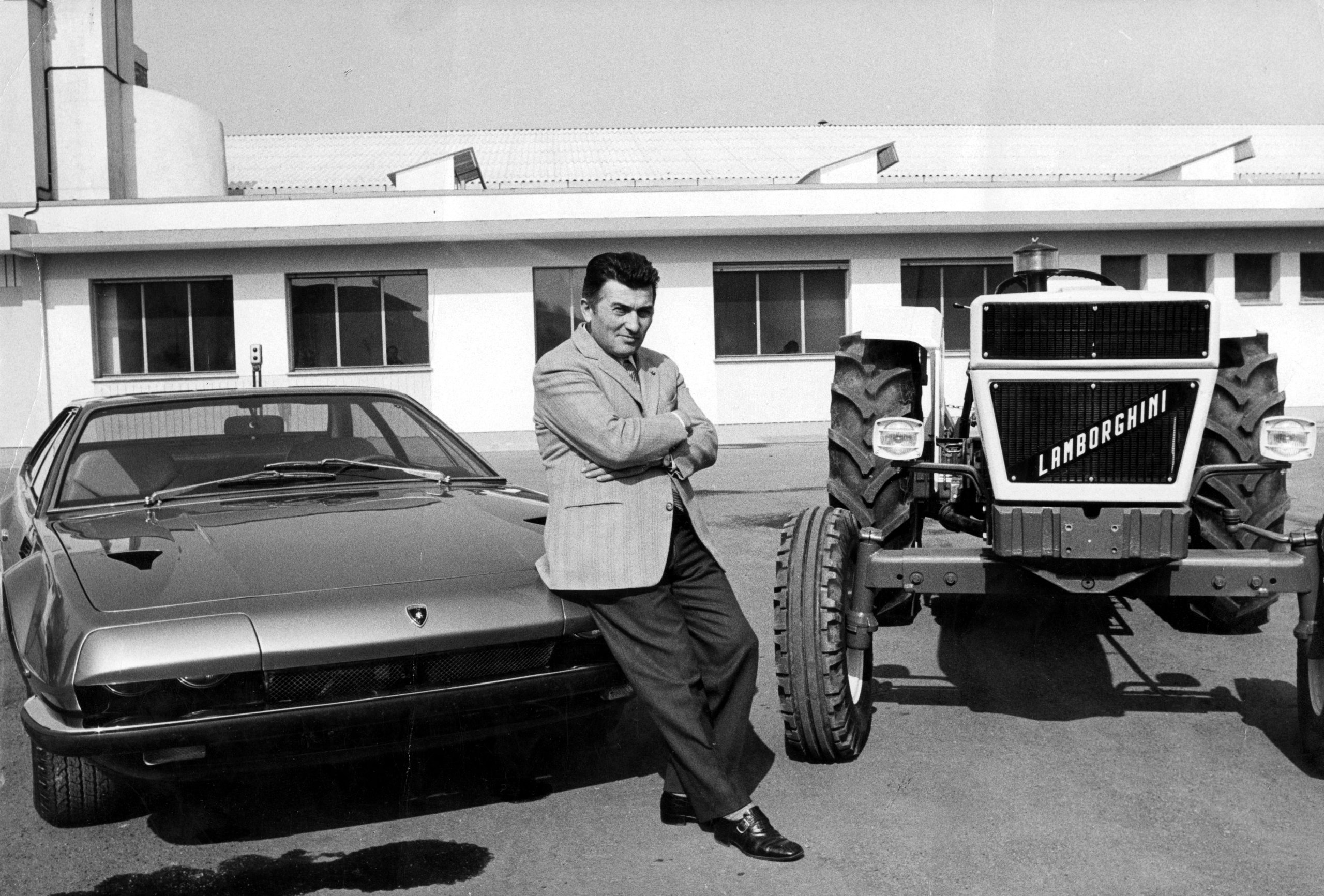 Lamborghini At 60: Global Owner Gatherings And Two 60-Unit Huracans Mark Six Decades Of Defiance 5 Black and white photograph of ferruccio lamborghini leaning against a lamborghini islero with a lamborghini tractor beside him outside the factory