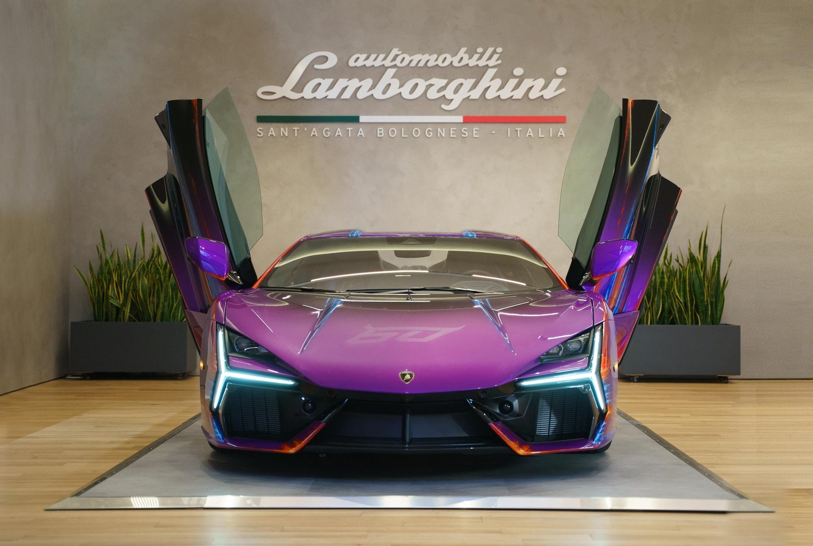 Lamborghini Revuelto Opera Unica with scissor doors open displaying its multi-color hand-painted exterior at the Lamborghini Lounge NYC