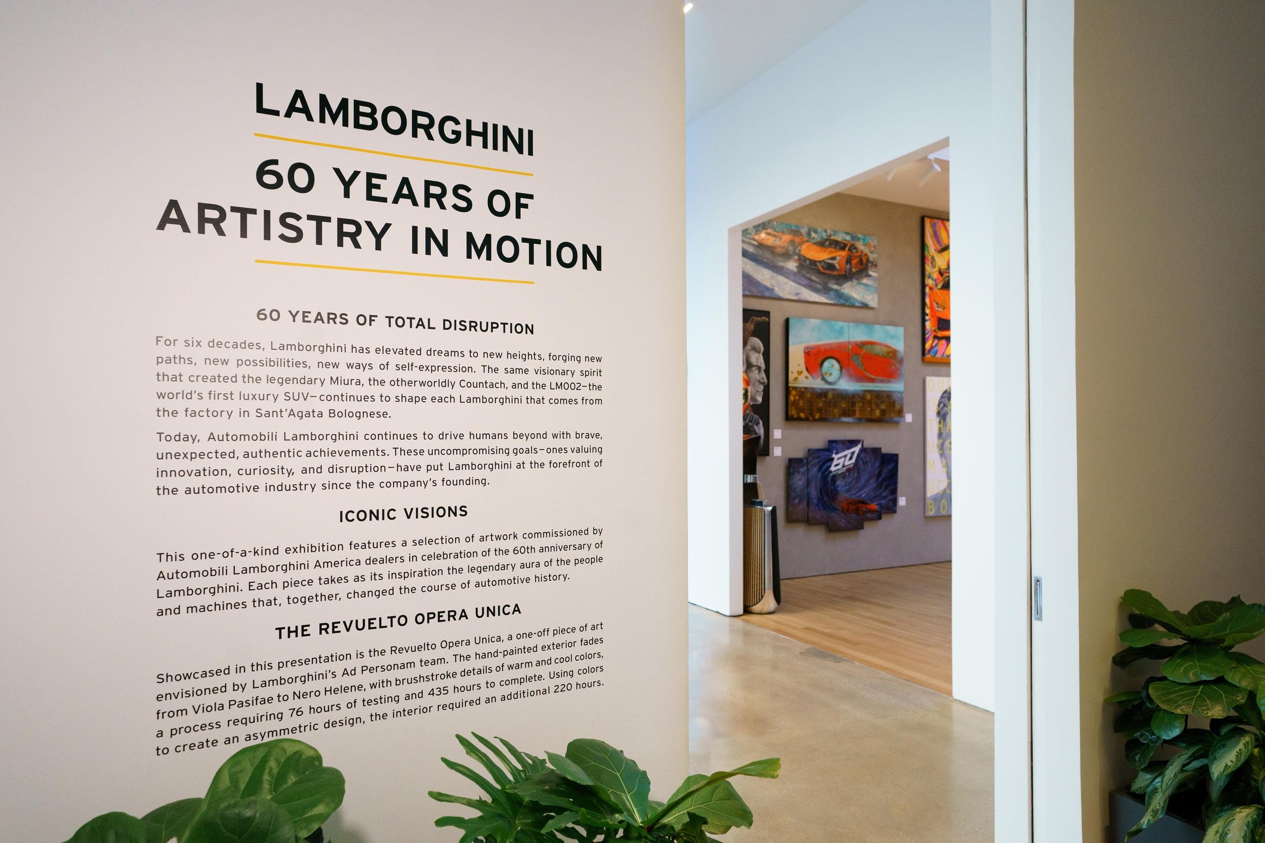 Why Lamborghini Opened Its Private Nyc Lounge To The Public For The First Time 5 Exhibition wall panel reading lamborghini 60 years of artistry in motion with gallery visible through archway