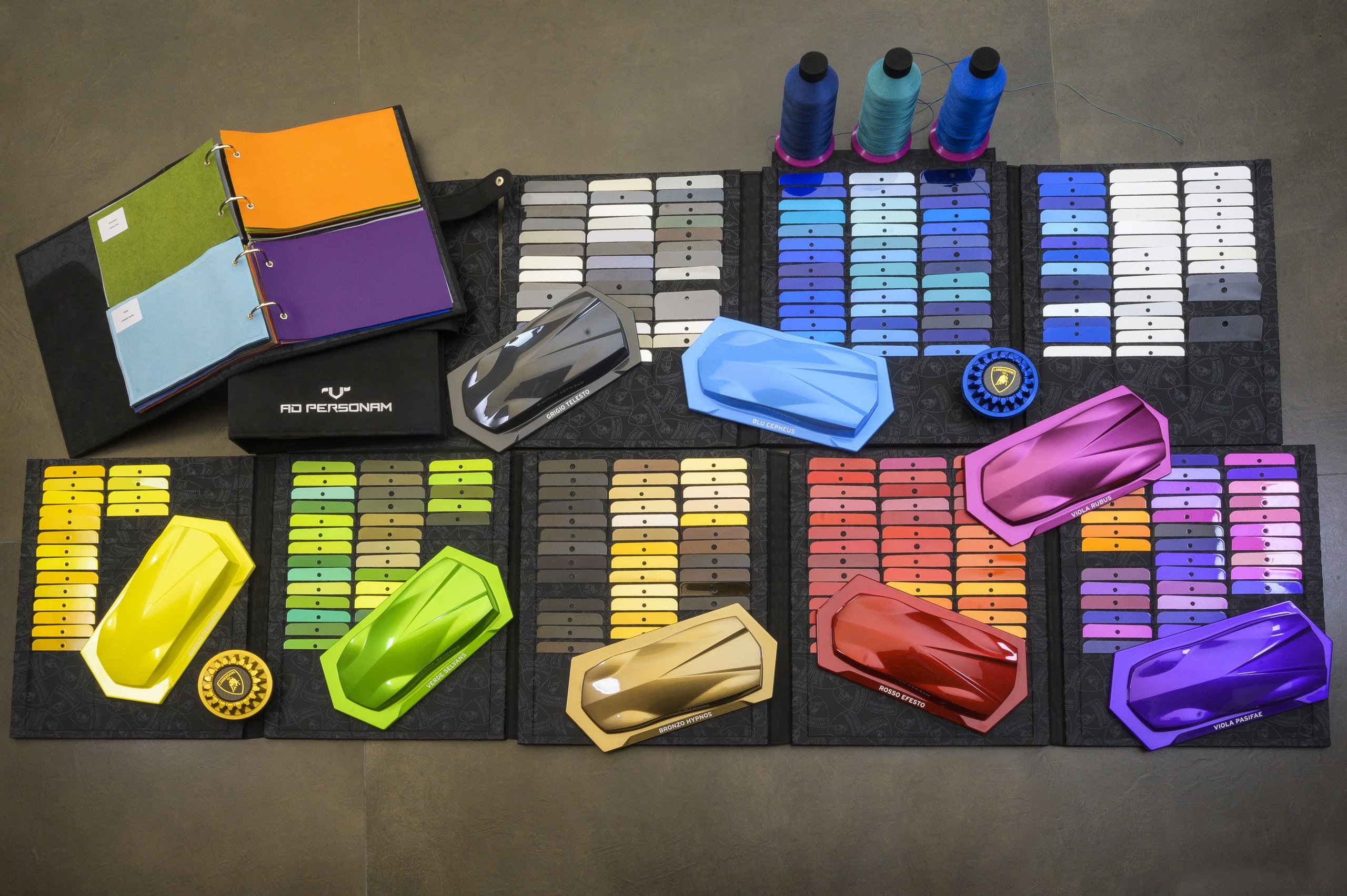 Diamond Dust Paint And Pet Portraits: Five Revelations From Lamborghini'S Ad Personam Program 7 Overhead view of extensive ad personam paint swatches, material samples, and miniature car models in various custom colors