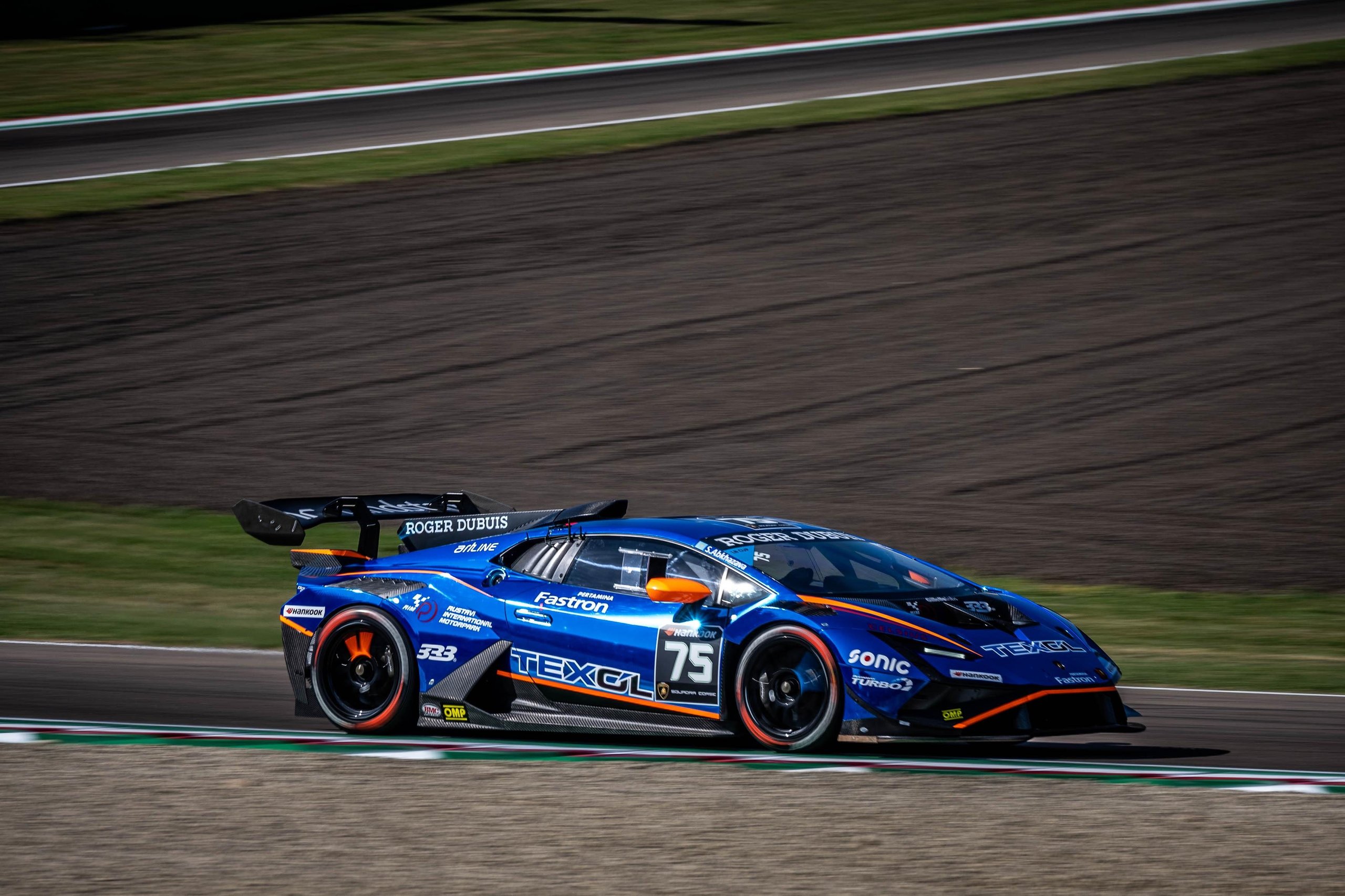 Lamborghini Arena 2026 Returns To Imola: Why The Brand'S Biggest Owner Gathering Matters More This Time 5 A blue lamborghini huracán gt3 evo race car number 75 speeding on a racetrack with sponsor decals