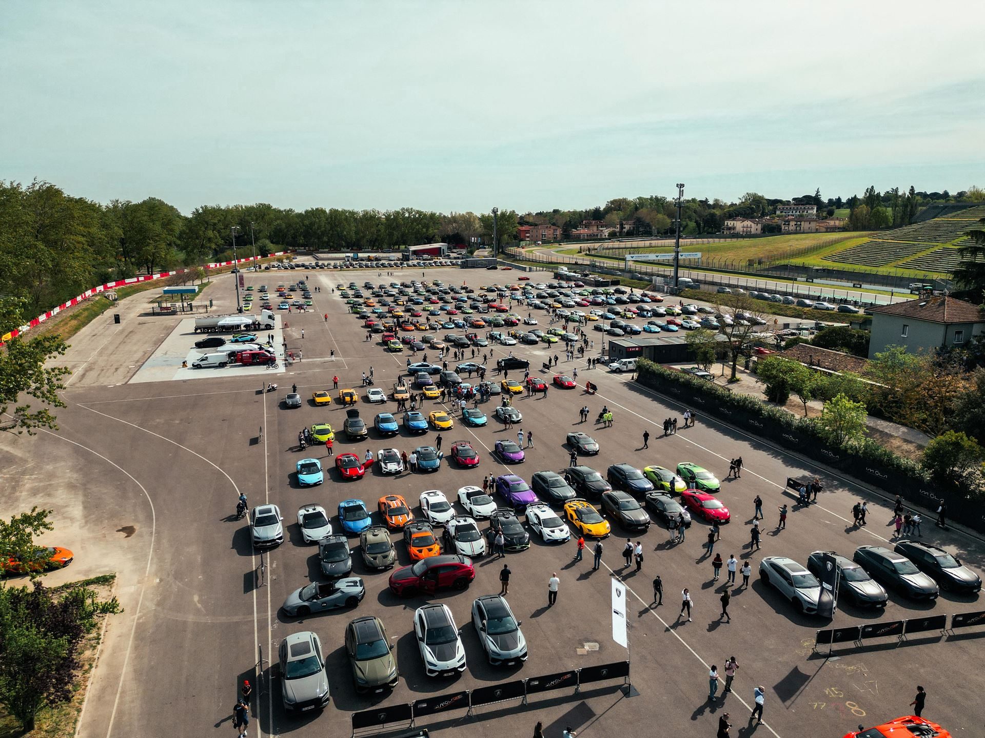 Lamborghini Arena 2026 Returns To Imola With Super Trofeo Racing, Miura Anniversary, And A Bigger Playbook 9 Aerial shot of a massive lamborghini owner parking area filled with models of every color at the imola event