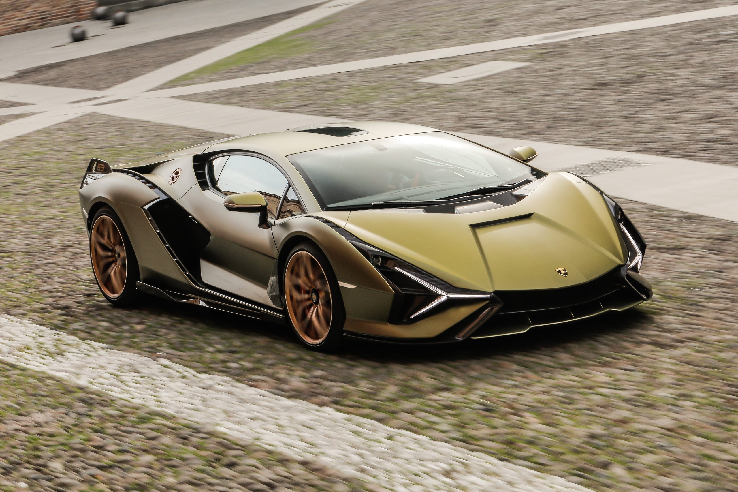 Lamborghini Doubled Its International Awards In 2021, And The Reasons Tell A Bigger Story Than The Trophies 7 Matte gold lamborghini sián fkp 37 driving on a cobblestone street with motion blur