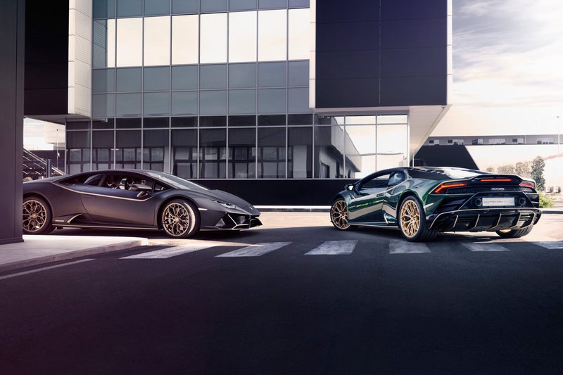 A matte grey Lamborghini Huracán STO and a green Huracán EVO parked facing opposite directions on a crosswalk, illustrating the range of Lamborghini's award-winning V10 lineup
