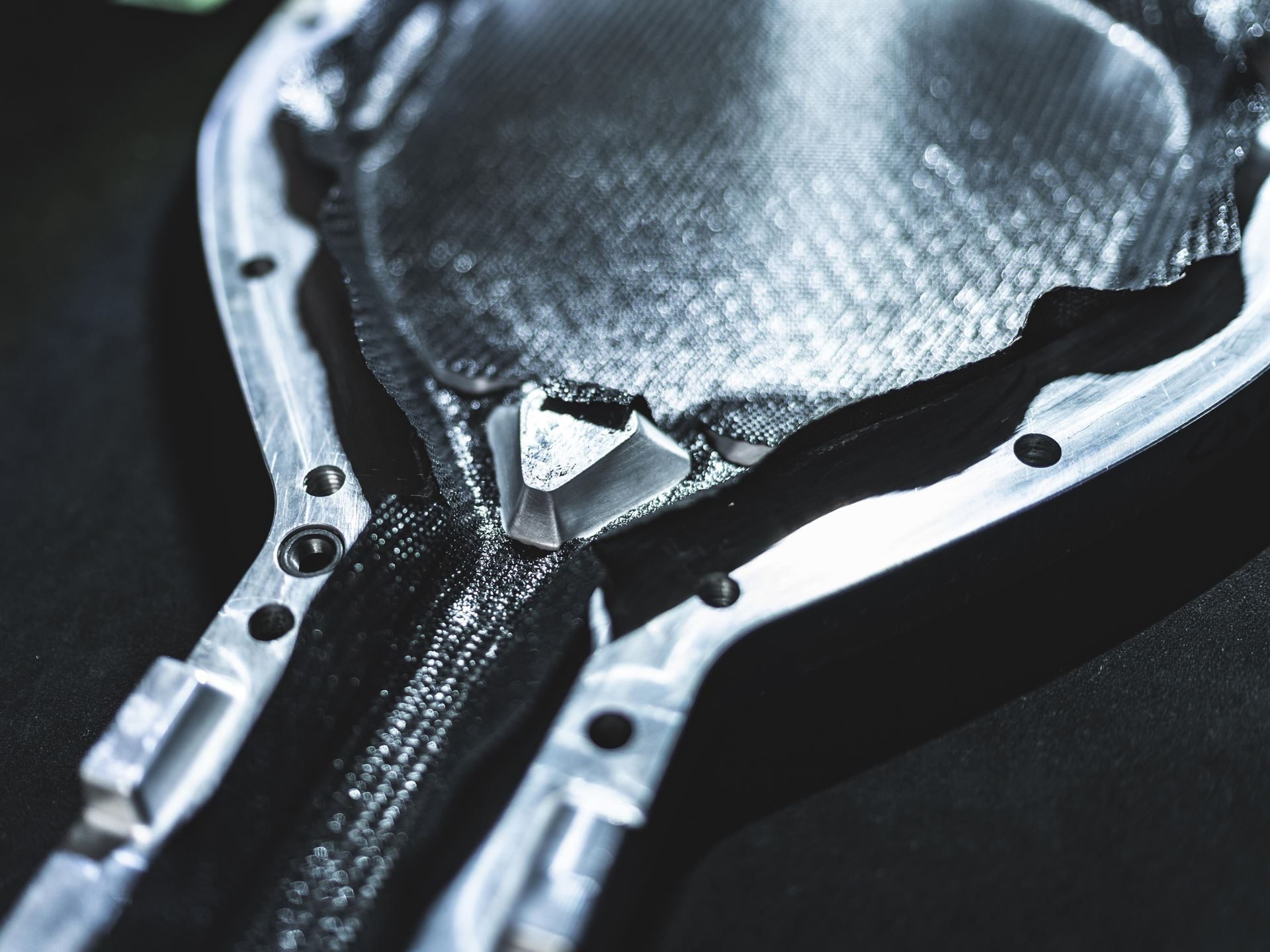 Lamborghini Builds 50 Padel Racquets In Its Supercar Factory, And That'S The Point 5 Close-up of woven carbon fiber material embedded within the metallic frame structure of the bl001 padel racquet