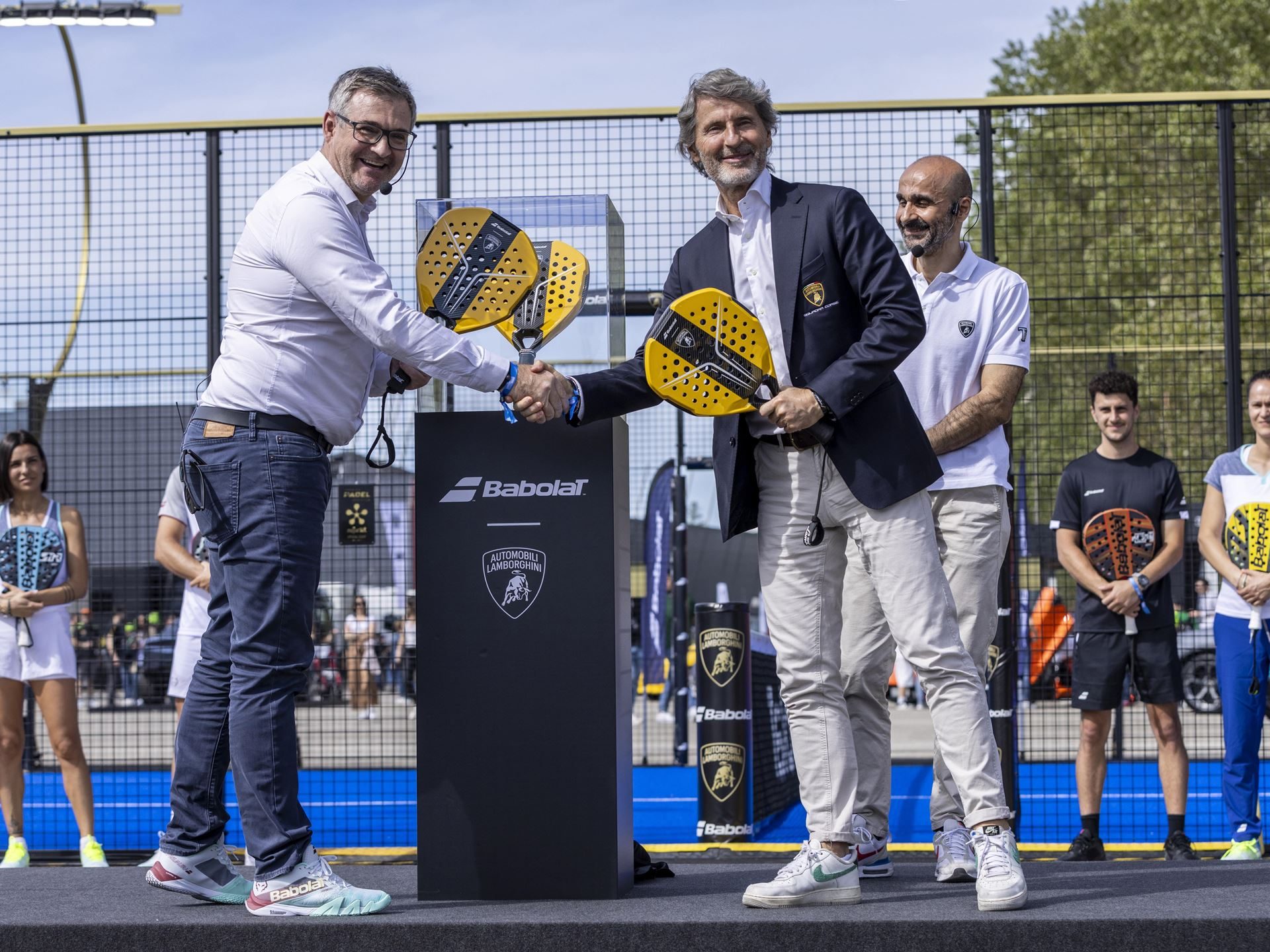 Lamborghini Builds 50 Padel Racquets In Its Supercar Factory, And That'S The Point 3 Stephan winkelmann and éric babolat shaking hands on the padel court, each holding a yellow bl001 racquet