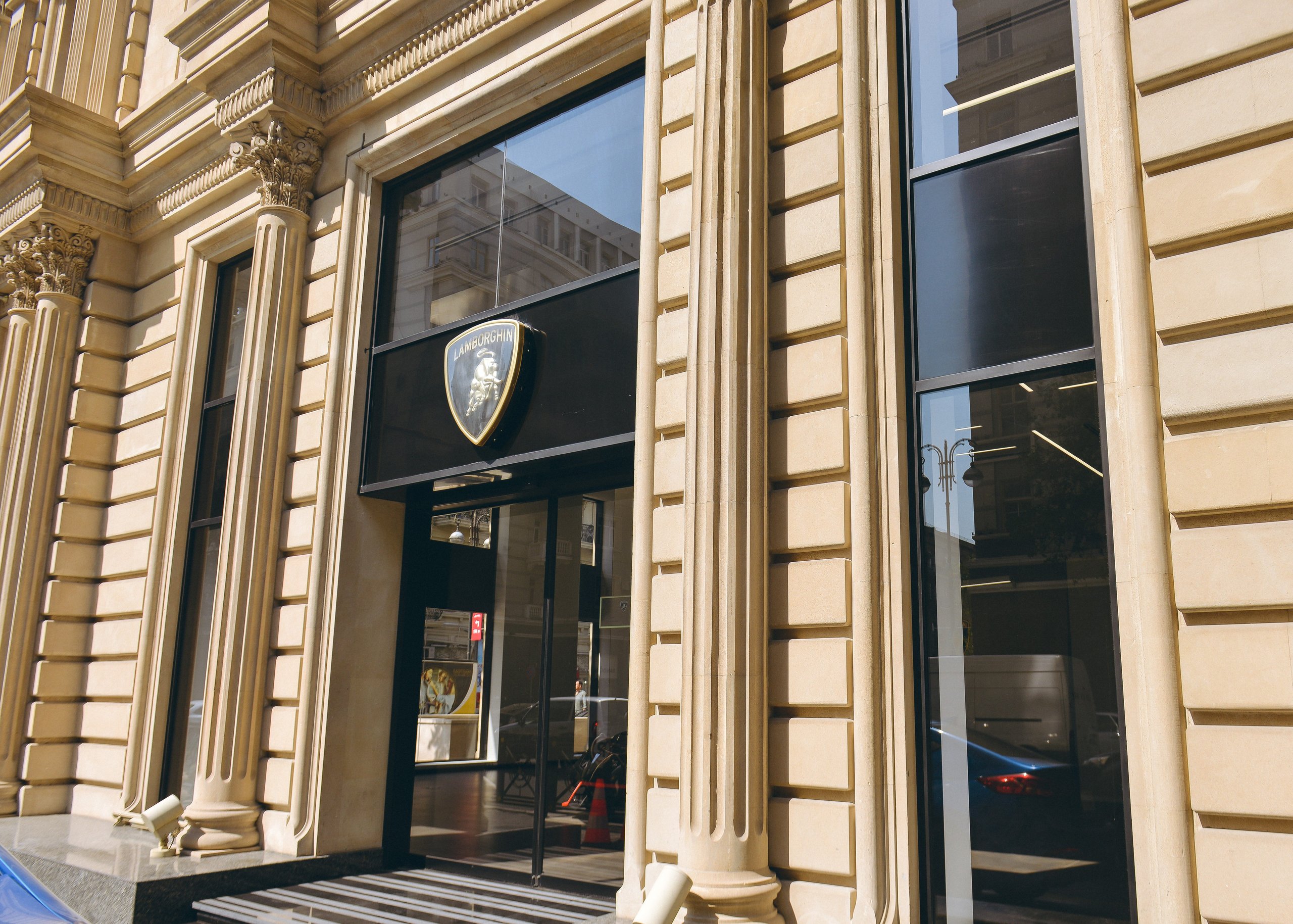 Lamborghini Baku: Why A 225 Square Meter Showroom Signals Serious Ambitions For The Transcaucasia Region 3 Exterior view of the lamborghini baku showroom entrance with the brand logo above the door, set within a classical architectural facade