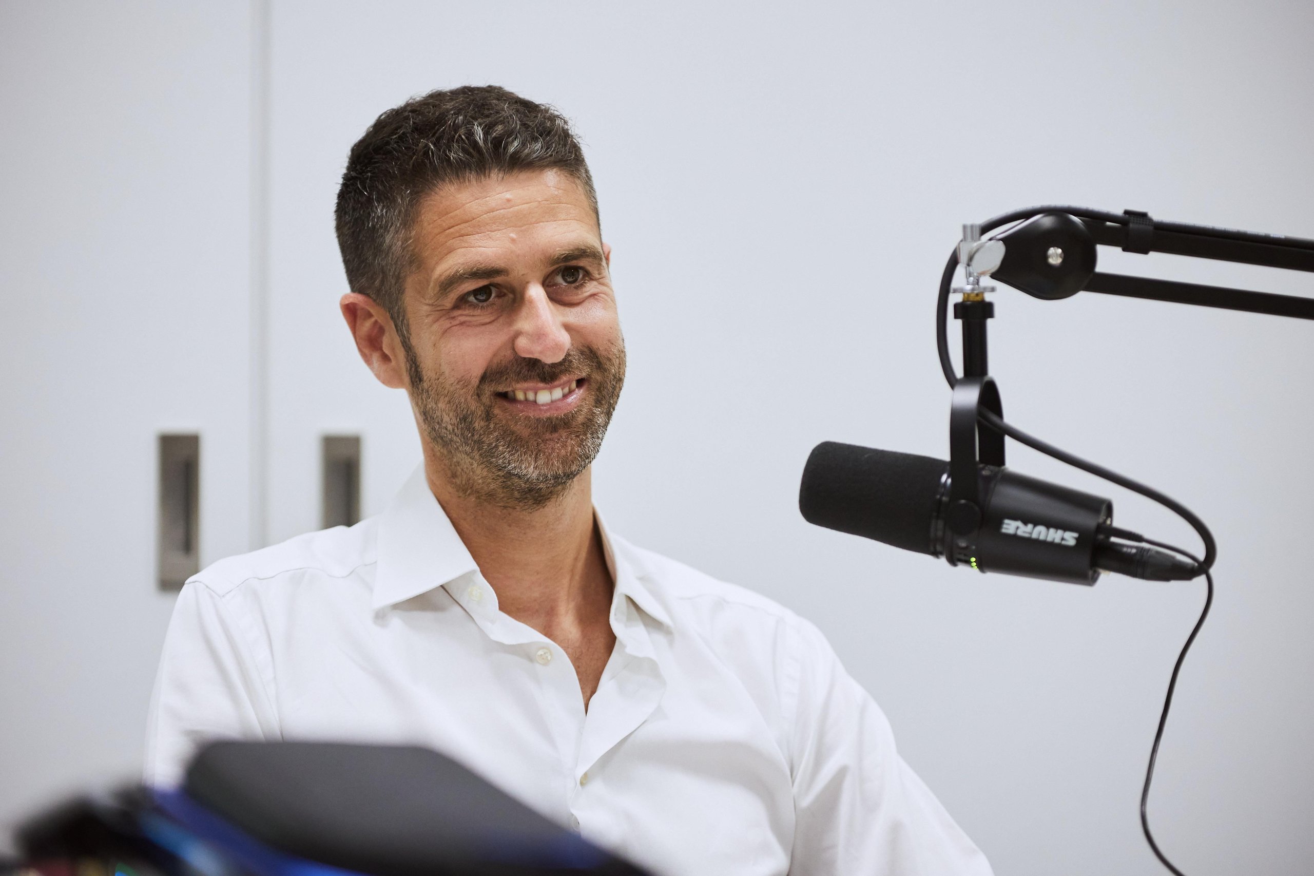 Inside Lamborghini'S 'Beyond' Podcast: How The Revuelto'S Product Director And Ducati'S Motogp Boss Define Winning Culture 3 Matteo ortenzi, lamborghini revuelto product line director, smiling during the beyond podcast recording with a professional microphone in the foreground