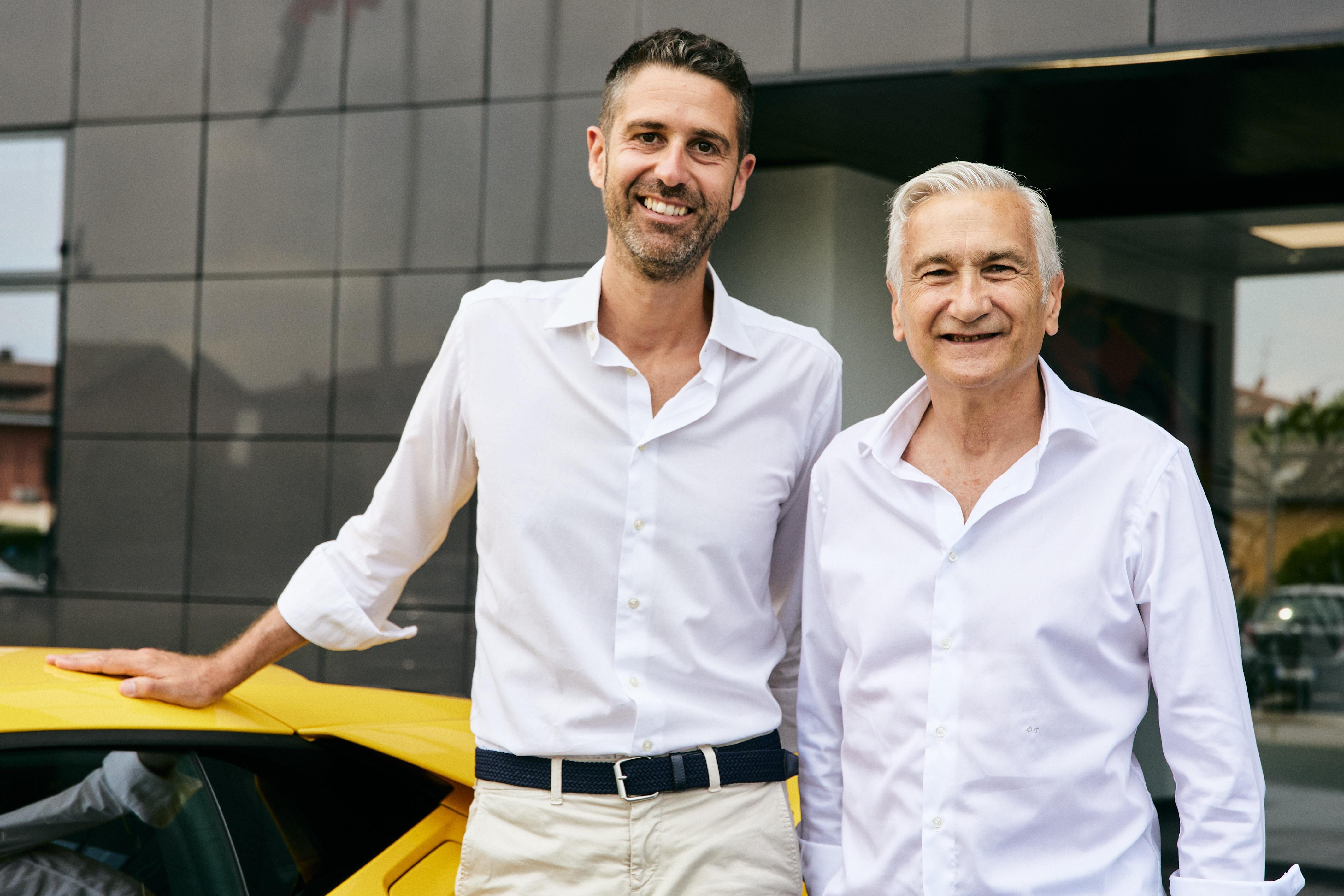 Inside Lamborghini'S 'Beyond' Podcast: How The Revuelto'S Product Director And Ducati'S Motogp Boss Define Winning Culture 7 Matteo ortenzi and davide tardozzi standing together in front of a modern building with a yellow lamborghini visible in the background