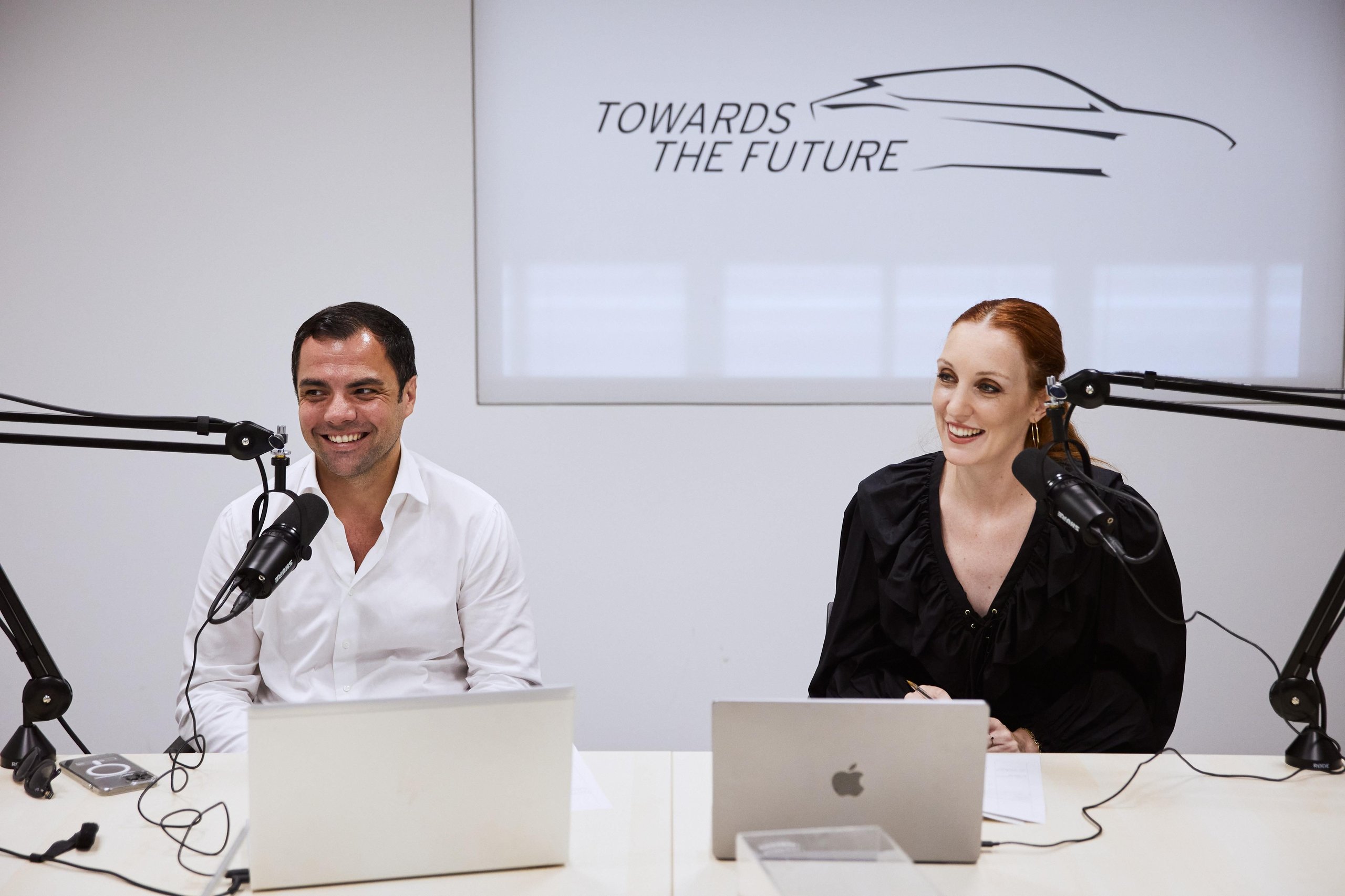 Inside Lamborghini'S 'Beyond' Podcast: How The Revuelto'S Product Director And Ducati'S Motogp Boss Define Winning Culture 11 Tim bravo and giulia salvi, hosts of beyond: a lamborghini podcast, seated at a table with microphones and a towards the future graphic behind them