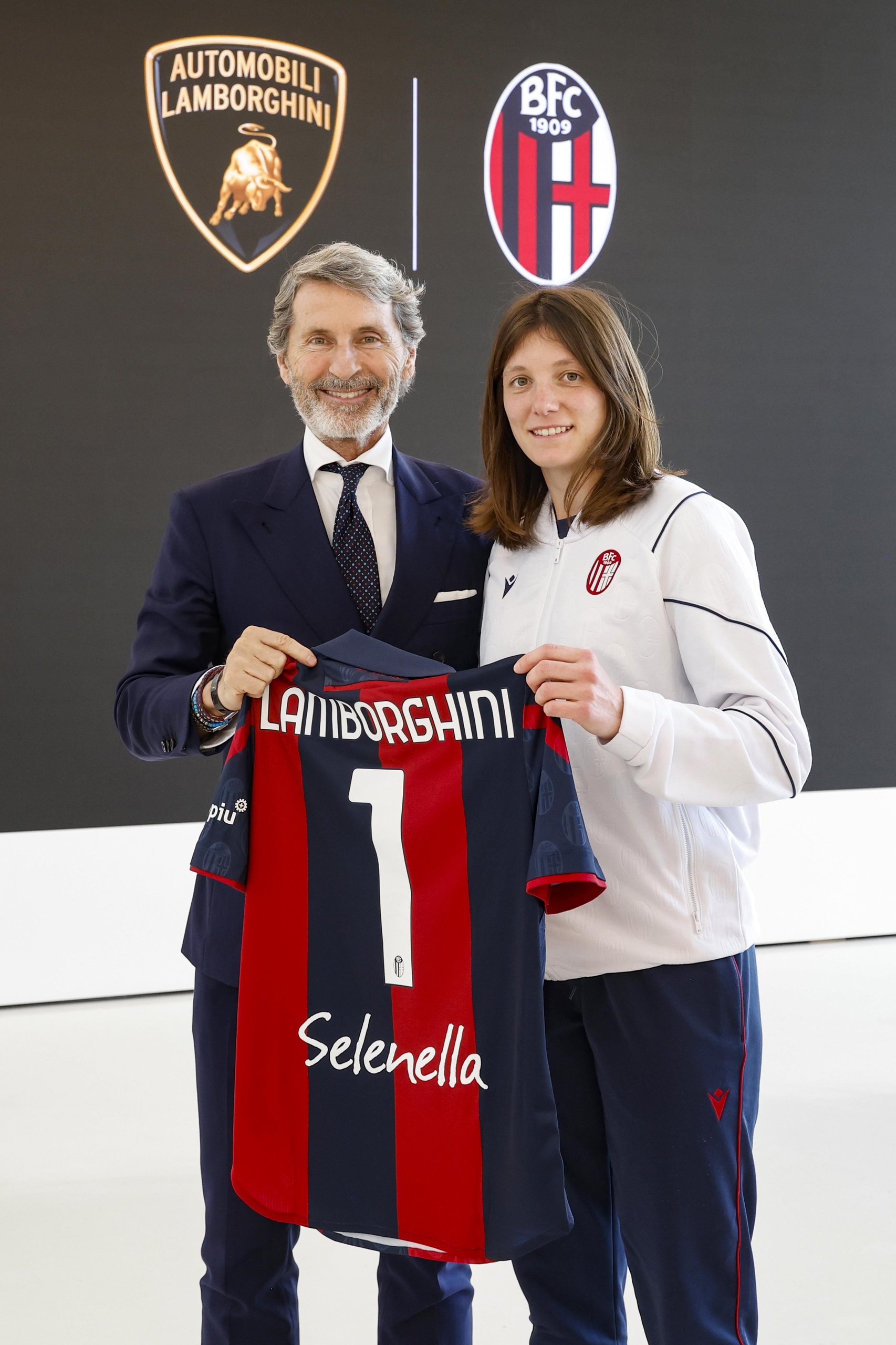 Lamborghini Brings Bologna'S Women'S Football Team To Sant'Agata, Signaling A Broader Brand Play 5 A lamborghini representative and a bologna fc femminile player hold a team jersey branded with lamborghini and selenella logos