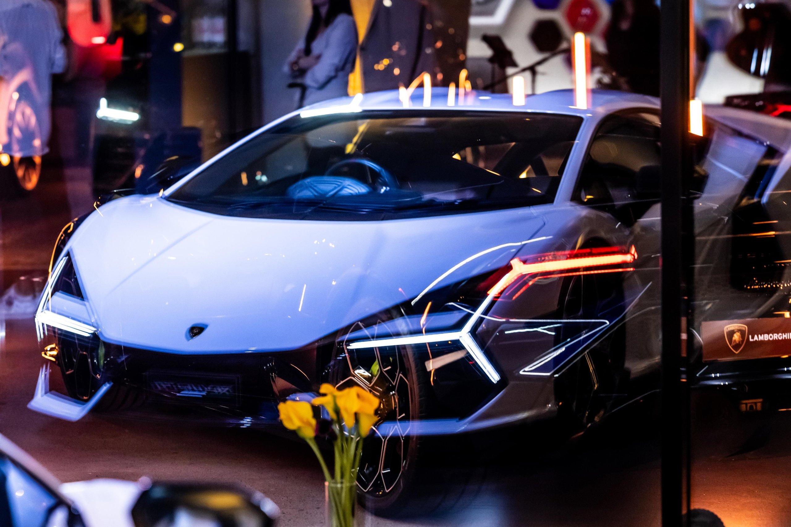 Budapest Gets Its First Lamborghini Showroom, And The Revuelto Came Along To Make The Point 5 Close-up front three-quarter view of the white lamborghini revuelto showing y-shaped led headlights and aggressive front design