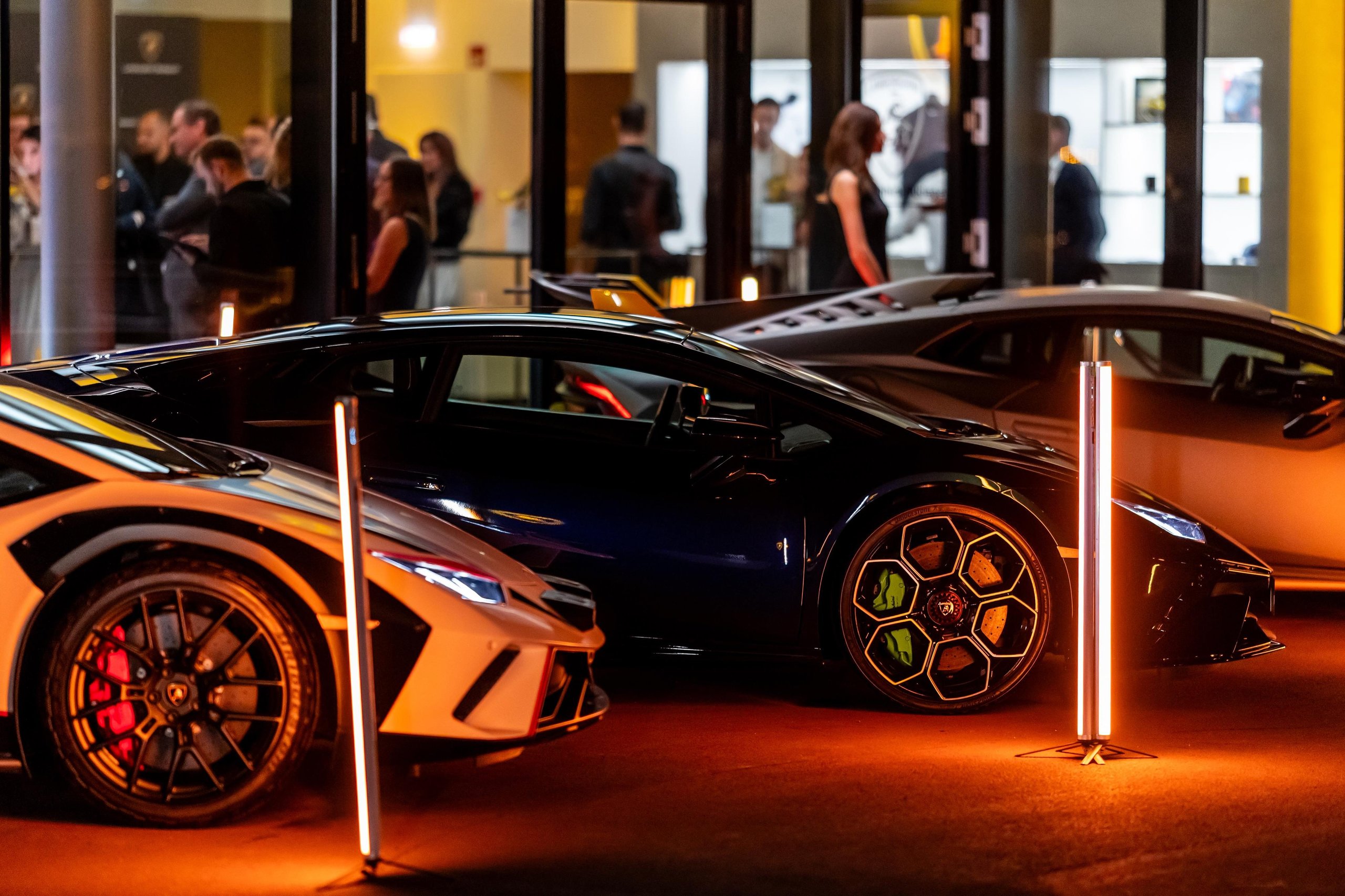 Budapest Gets Its First Lamborghini Showroom, And The Revuelto Came Along To Make The Point 7 White lamborghini revuelto and dark blue huracán displayed side by side at the budapest showroom event